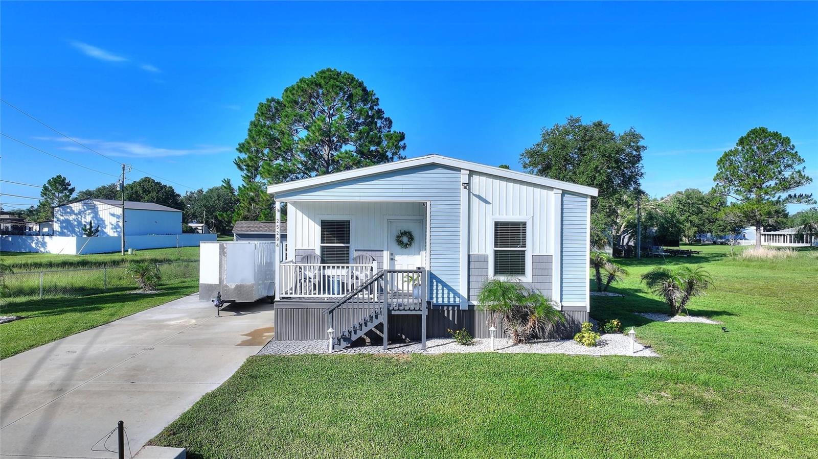 Discover this like-new 2023, 2-bedroom, 2-bath home with a versatile flex room in the peaceful River Ranch Shores community, where modern comfort meets the beauty of Old Florida. Whether you're searching for a full-time residence, weekend getaway, vacation home, or investment opportunity, this property offers an exceptional location just moments from the world-famous Westgate River Ranch Resort & Rodeo. Designed with today's lifestyle in mind, the open floor plan creates a bright, welcoming space for entertaining and everyday living. The spacious kitchen overlooks the dining and living areas, while the split-bedroom layout provides privacy for family and guests. The flex room is ideal for a home office, hobby room, or additional sleeping space. The primary suite features dual vanities, a walk-in shower, and generous storage, while the second bedroom and full bath provide comfortable accommodations for visitors. An interior laundry room adds convenience to this thoughtfully designed home. Step outside and enjoy Florida living from the covered front porch or relax in the fully fenced backyard. The property also includes an RV hookup, a storage shed that's perfect for a golf cart or outdoor equipment, and plenty of room for additional parking, making it easy to enjoy everything this outdoor paradise has to offer. One of the property's biggest advantages is its incredible location. Just a short golf cart ride from Westgate River Ranch Resort & Rodeo, you'll have easy access to an exciting new waterpark, championship rodeos, air boat and swamp buggy rides, horseback riding, zip lining, archery, dining, live entertainment, seasonal events, luxury glamping, and family attractions that draw visitors year-round. With no HOA and no CDD fees, buyers seeking a personal retreat or a property with short-term rental potential will appreciate the flexibility this location offers. Buyers should verify all local zoning requirements and rental regulations. Outdoor enthusiasts will love being close to Lake Kissimmee, known for world-class bass fishing, boating, air boating, wildlife viewing, and endless recreational opportunities. Conveniently located within reach of Orlando, Tampa, and Florida's beautiful east and west coasts, this home offers the perfect balance of peaceful country living and easy access to some of Florida's most popular destinations.
If you've been searching for a newer home near Westgate River Ranch with no HOA, RV hookup, golf cart storage, and endless opportunities to enjoy the Florida outdoors, this is one you won't want to miss. Schedule your private showing today!