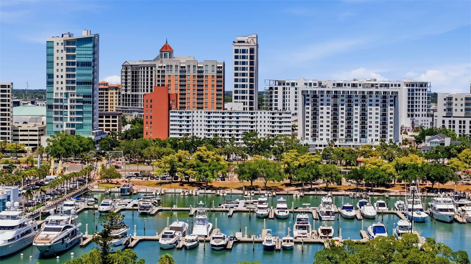 Discover the ultimate downtown Sarasota lifestyle from this beautifully maintained fourth-floor condominium offering partial Sarasota Bay, Bayfront Park, and Marina Jack views. Perfectly positioned at the coveted corner of Main Street and Gulfstream Avenue, this residence places the very best of Sarasota just outside your front door.

Step inside to find expansive living spaces, wood-look tile flooring throughout, abundant natural light, and a warm modern aesthetic that complements the building's timeless mid-century architecture. The spacious primary suite offers comfort and privacy, while the retro-inspired bathroom preserves the character and charm that make this residence truly unique.

Enjoy spectacular sunset skies from the comfort of your living room or take a short stroll to Sarasota's vibrant waterfront, renowned restaurants, boutique shopping, theaters, art galleries, farmers market, and year-round cultural events. Whether enjoying morning walks along the bayfront or evenings dining downtown, every day feels like a vacation.

This well-maintained community offers exceptional amenities including a resort-style pool and expansive sun deck, social room with kitchen and dining area, refurbished lobby and common areas, updated elevators, impact-resistant windows, and attractive brick paver decking.

Ideal as a primary residence, seasonal retreat, or investment opportunity, this is a rare chance to own in one of Sarasota's most desirable downtown locations where waterfront living, walkability, and urban convenience come together seamlessly.
