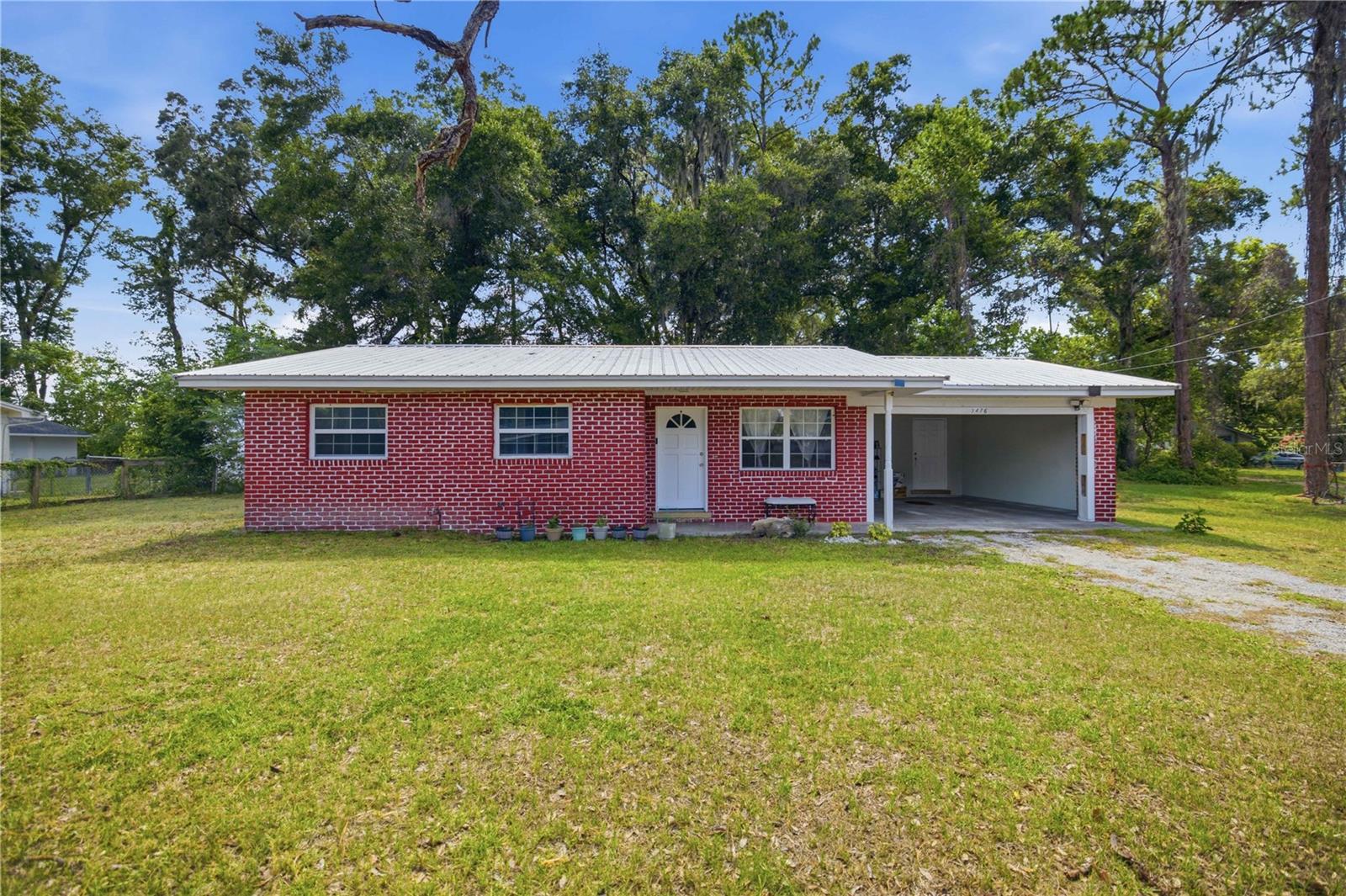Fully Renovated in 2020! Turnkey 3 Bed/2 Bath Block Home. Located just 3 minutes from Publix and a short drive to a wide array of shopping, dining, entertainment, parks, and recreation. NO HOA, NO Flood Zone! The property features; metal roof, tile flooring throughout, family room, inside laundry room, screened-in lanai, and private yard with no rear neighbors. Equipped kitchen offers; modern appliances, new gas stove, new cabinets, granite countertops, and breakfast room. The bathrooms have been tastefully updated with new sink vanities, faucets, fixtures, and showers. The carport was formerly a 4th bedroom and can easily be reconverted or make it a garage if desired. Additional storage is available in the 8x16 utility room. Outdoor features include; a fenced backyard, storage shed, and a 16x14 concrete pad ready for your vision. Upgrades include; Metal Roof, Soffit, HVAC, Plumbing, Electrical, Flooring, Drywall, Windows, Bathrooms, Kitchen, Appliances, Cabinetry, and Countertops.