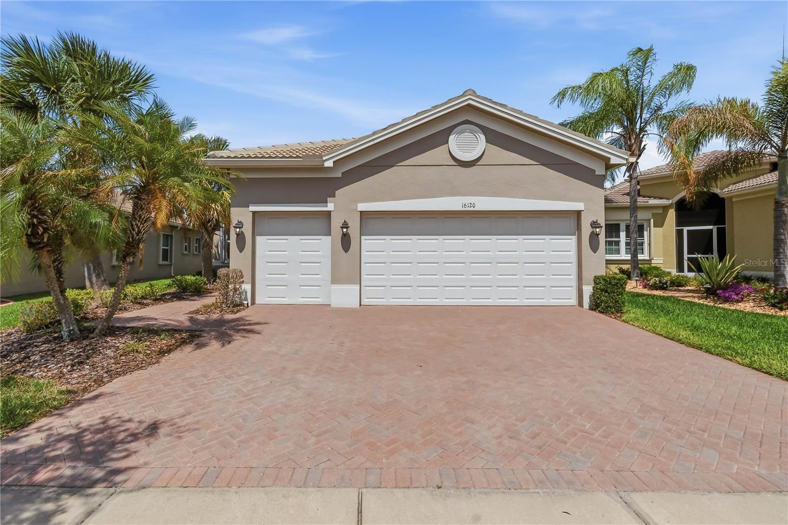 Welcome home to this beautifully maintained Palazzo model in the sought after 55+ community of Valencia Lakes! Built in 2016 and offering 2,185 square feet, this thoughtfully designed residence features 3 bedrooms, a den, 2.5 bathrooms, and an oversized 2.5 car garage, giving you the perfect blend of comfort, function, and Florida lifestyle.

From the moment you arrive, the attractive curb appeal, lush landscaping, and elegant double leaded glass entry doors create a warm welcome. Step inside to an open and airy floor plan featuring diagonal tile flooring throughout the main living areas, neutral décor, and a move in ready feel that makes settling in effortless.

Designed for both everyday living and entertaining, the spacious great room showcases a beautiful coffered ceiling and seamlessly flows into the dining area and kitchen. Large sliding glass doors open to the extended screened lanai, creating the perfect indoor outdoor living experience with peaceful, private views ideal for morning coffee or unwinding at the end of the day.

The kitchen is both stylish and functional, offering white wood cabinetry, extensive counter space, pull out drawers, under and upper cabinet lighting, glass accent cabinetry, a tiled backsplash, and a Bosch dishwasher. A sunny casual dining space framed by tropical views makes this kitchen as inviting as it is practical.

The spacious primary suite is a true retreat, complete with a coffered ceiling, two large walk in closets with organizers, and a spa inspired ensuite bath featuring dual sinks, abundant counter space, wood cabinetry, linen storage, and a large walk in shower.

Guests will appreciate two generously sized secondary bedrooms and a conveniently located full bath, while the versatile den offers the perfect space for a home office, hobby room, or optional fourth bedroom. A separate half bath adds additional convenience.

Additional features include a laundry room with washer and dryer, water softener, and accordion hurricane shutters throughout for added peace of mind. The oversized garage provides plenty of room for storage, a workshop area, or even your golf cart to enjoy everything the community has to offer.

Living in Valencia Lakes means more than owning a home, it means embracing a resort lifestyle every day. Residents enjoy a stunning clubhouse, resort style pool, lap and resistance pools, fitness center, social hall, clubs, classes, card rooms, walking paths, sports, and countless activities in one of Florida’s premier 55+ communities.

Come experience the lifestyle you’ve worked for and deserve. Make an appointment today!