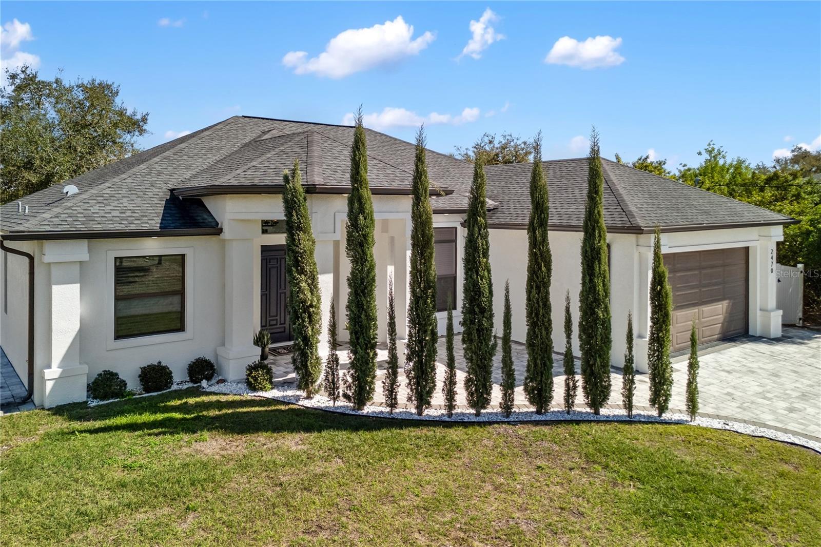 Affordable Luxury in the PRIME LOCATION of North Port, Florida! Discover refined living in this beautifully designed home offering over 2,700 square feet of thoughtfully crafted space. With high-end finishes this property delivers comfort, style, and value all in one. 4 Generously Sized Bedrooms, 2 Well-Appointed Bathrooms and 2-Car Garage! From the moment you step inside, you'll notice the impressive high and tray ceilings that enhance the open, airy layout. The main living area is warm and inviting, featuring an electric fireplace with custom built-ins-perfect for cozy evenings or hosting guests. The chef-inspired kitchen is a true showpiece, boasting sleek quartz countertops and quartz backsplash, a large waterfall island, high end appliances makes perfect space for entertaining. The luxurious primary suite offers a spacious retreat featuring a large walk-in closet, dual vanities, stunning freestanding soaking tub, and a beautifully designed walk-in shower for a true spa-like experience. Two well-appointed guest bedrooms, offering comfort and convenience for family and or visitors. An additional - 4th versatile bedroom provides the perfect space for a private home office, study, or extra guest room to suit your needs. A convenient indoor laundry room adds everyday functionality. Enjoy added value with a whole-house R/O REVERSES OSMOSIS SYSTEM insuring quality water throughout the home. Step out to the & screened lanai and unwind in your private partially fenced backyard retreat. Backing up to a peaceful canal - you'll appreciate the added privacy and relaxing water views. Ideally situated in North Port, FL with an easy access to I-75 you're just minutes from the future Sarasota Memorial Hospital, shopping, dining, Downtown Wellen Park, North Port Aquatic Park, and the beautiful Gulf Coast beaches. No HOA's, no CDD's. This home combines elegance, comfort, and location-don't miss the opportunity to make it yours!