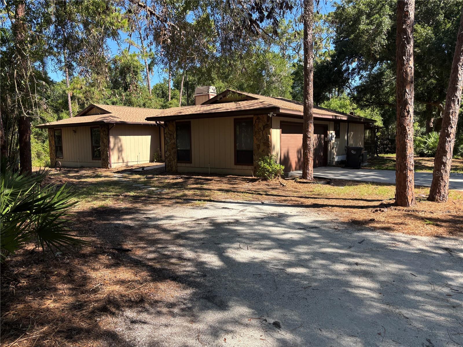 LOCATION - LOCATION - LOCATION -- Situated on an Acre of land amongst the pine trees.  This private and secluded 3 bedroom, 2 bath, 2 car garage home offers a place to park a boat or RV.  Kitchen has been updated with new cabinets, countertops and upgraded SS appliances.  Fresh paint throughout home, new plank flooring in living/dining room areas and new carpet in all 3 bedrooms.  Braden Woods is approximately 2 miles from I-75 and there is abundant shopping, dining and entertainment galore as Lakewood Ranch is right next door.  Linger Lodge is accessible at the south end of Braden Woods.