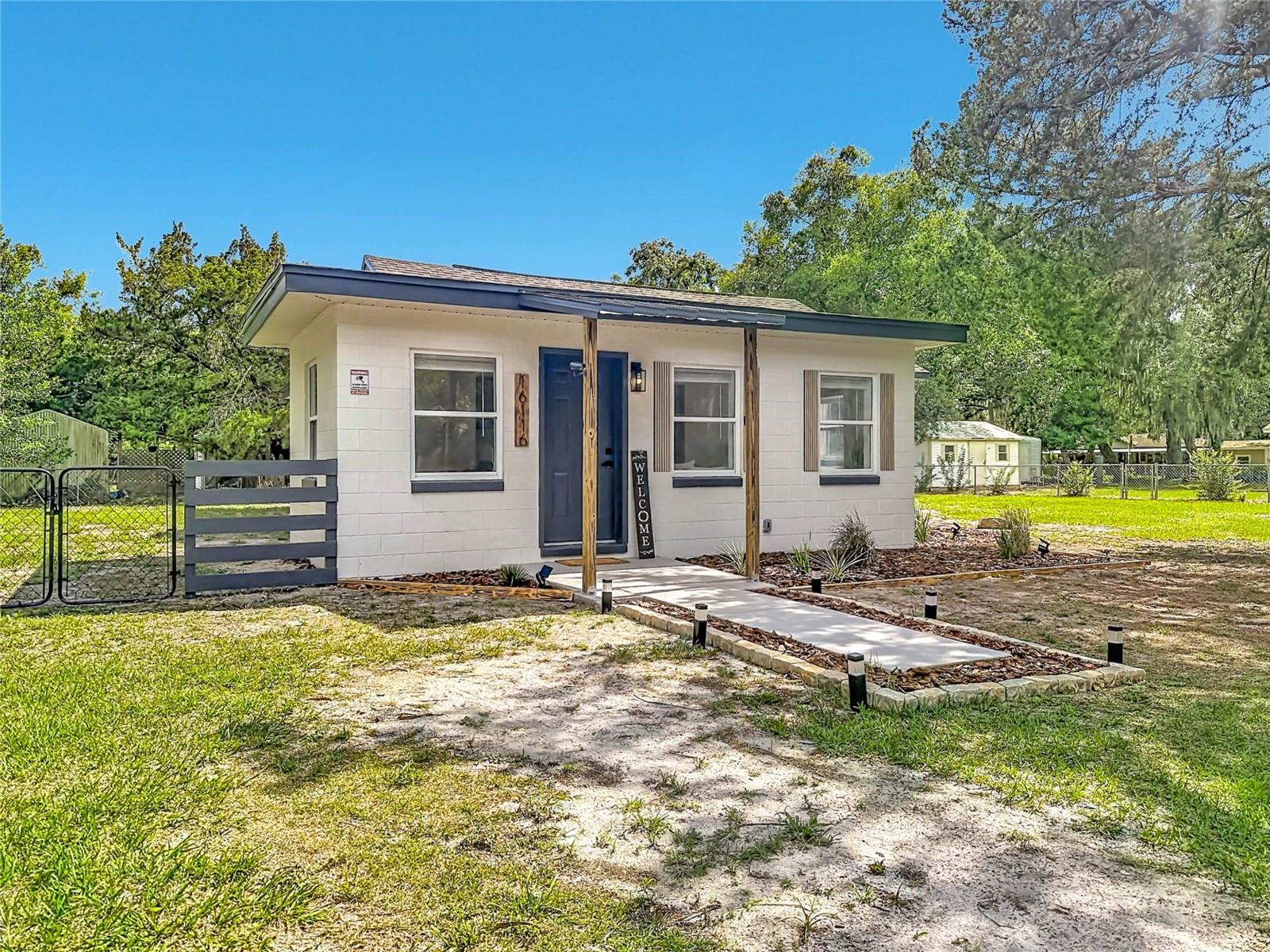Nestled in the charming heart of Umatilla, this absolutely adorable move-in ready home is bursting with warmth, character, and small-town charm. Beautiful with some lovely updates while still maintaining its cozy and inviting feel, this special property welcomes you from the moment you arrive with a softly lit walkway, charming wooden beam accents, and cheerful pops of color that instantly make you feel at home.

Step inside and fall in love with the light and airy layout where every space flows effortlessly together, creating the perfect setting for both quiet evenings at home and gathering with family and friends. The welcoming front parlor opens beautifully into the formal dining area with additional seating space, all leading into a charming kitchen filled with abundant counter space, natural light, and peaceful views overlooking the backyard.

Tucked privately toward the rear of the home, the primary suite offers a peaceful retreat complete with its own private entrance — ideal for guests, a cozy in-law setup, or even a potential rental opportunity. Throughout the home you’ll notice thoughtful details and tasteful touches that create a truly inviting atmosphere. The bathrooms feel like a relaxing spa escape with stunning tile work, warm wooden accent vanities, and carefully selected finishes that add charm and personality throughout.

Step outside and enjoy the simple beauty of Florida living. The expansive back patio is perfect for sipping morning coffee, grilling with loved ones, enjoying quiet evenings under the stars, or simply soaking up the sunshine. The spacious yard has been lightly landscaped and offers the perfect canvas to create your own dreamy garden, outdoor retreat, or backyard oasis. The home is on well and septic, offering the charm and independence of country living, and also features a brand new well pump for added peace of mind.

Lovingly known as “Nature’s Hometown,” Umatilla offers a lifestyle that feels peaceful, scenic, and refreshingly tucked away from the hustle and bustle. As the gateway to the Ocala National Forest, this area is a dream for outdoor lovers with endless opportunities nearby for fishing, boating, hiking, kayaking, camping, and exploring Florida’s beautiful natural springs, lakes, and wooded trails. Imagine weekends spent out on the water, afternoons wandering scenic hiking paths, and evenings enjoying the quiet beauty of true country living.

If you’ve been searching for a home that offers charm, privacy, outdoor adventure, and the comfort of small-town living while still being conveniently close to Downtown Eustis, this enchanting property may be exactly what you’ve been waiting for. USDA eligible and NO HOA!
