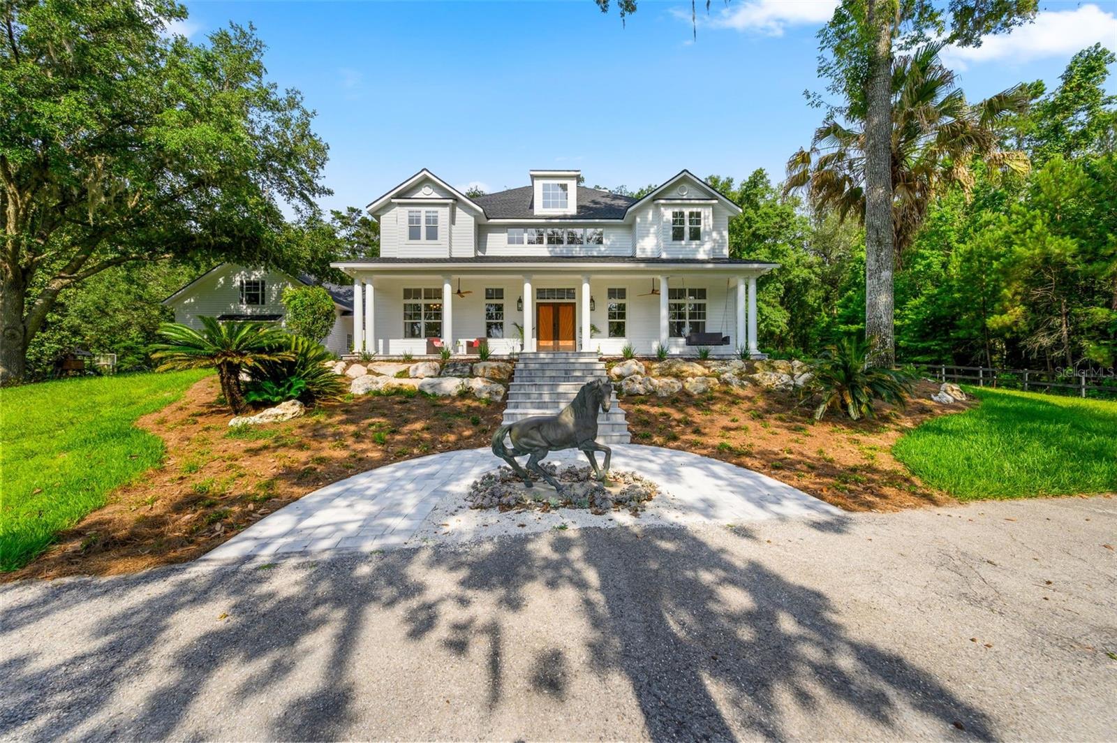 Auction Property. Auction Property: List price may not reflect final sales price. List price is starting bid on the property and is non-reflective of value. Auction Ends August 14th at 4PM. Buy now option available as well. Stunning 47-Acre Gated Equestrian Estate in Gainesville, FL! This exceptional multigenerational ranch offers privacy, rolling hills, breathtaking sunset views, and borders protected conservation land that will never be developed. The beautifully updated two-story home features a new 2025 roof, fresh interior and exterior paint, new landscaping, and new paver porches, patios, and walkways. Inside, enjoy a chef's kitchen with dual farmhouse sinks, walk-in pantry, seating for 13, three laundry areas, and two fireplaces. Outdoor amenities include a pool, spa, hot tub, covered patio with fireplace, three-car garage, automatic gated entrance, playground, and chicken coop. Designed for equestrian and agricultural living, the property features a 10-stall horse barn with air-conditioned tack room, grooming and wash stalls, lighted training arena, training circles, approximately 25 acres of fenced paddocks, horse pasture, pole barn with hay storage, multiple storage buildings, and RV storage. Turkey Creek winds through the property, with wooded riding trails, abundant wildlife, and excellent hunting opportunities. Additional highlights include private well with filtration system, agricultural well, septic, rare three-phase electric service, and 5 potential buildable lots, making this an ideal family compound, working ranch, or investment opportunity. This remarkable property combines luxury living, turnkey equestrian facilities, and endless possibilities in one of Gainesville's most scenic settings.