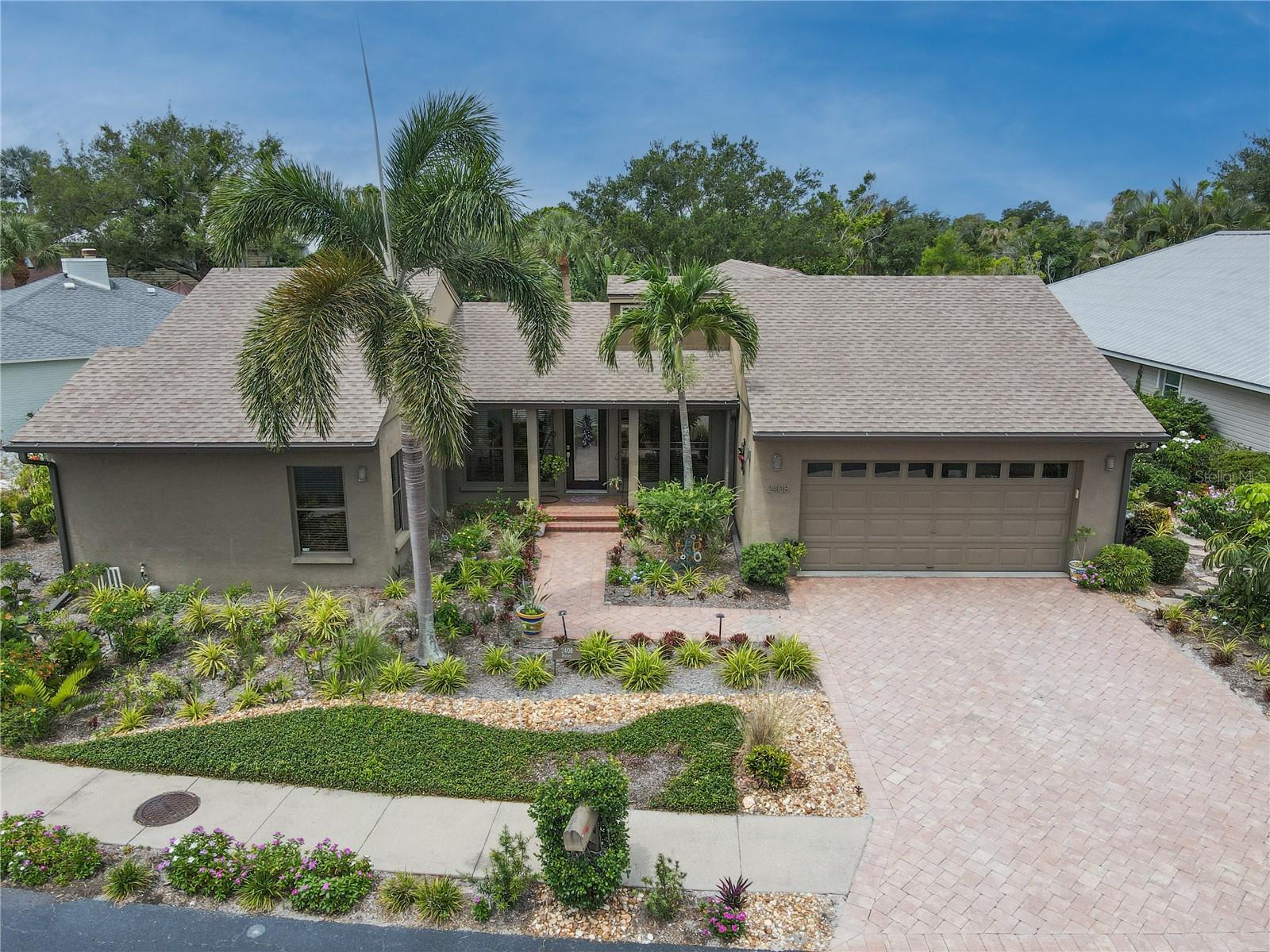 NW Bradenton Pool Home in Waterfront Community Near Anna Maria Island. This distinctive residence showcases an eclectic blend of coastal, contemporary, and Mediterranean influences, creating a one-of-a-kind living experience. This unique 3-bedroom, 2-bath home is located in one of Northwest Bradenton's most desirable maintenance-free waterfront communities. Ideally located just minutes from Anna Maria Island Beaches, Robinson Preserve, Warner Bayou's public boat ramps, shopping, dining, and medical facilities, this exceptional residence offers the perfect combination of privacy, comfort, and the Florida coastal lifestyle.The open-concept floor plan is designed for both everyday living and entertaining. The spacious kitchen features granite countertops, luxury wood cabinetry, and a seamless flow into the main living and dining areas. The primary suite serves as a private retreat with a spa-inspired bathroom featuring a garden tub, walk-in shower, and custom walk-in California Closet. Both guest bedrooms also include California Closets, providing outstanding organization and storage. Enjoy beautiful open-space views, mature tropical landscaping, and your own private pool. The expansive wraparound screened lanai creates the perfect setting for morning coffee, outdoor dining, or relaxing evenings year-round. The oversized garage includes a mini-split AC system, adding comfort and flexibility for hobbies, exercise space, or additional workspace.  Lawn maintenance is included, allowing for truly carefree living. Residents enjoy exclusive access to resort-style amenities, including a waterfront community pool, tennis/pickleball court, a clubhouse with a full kitchen, and a private fishing dock overlooking Tampa Bay. From the dock, enjoy breathtaking views of the Skyway Bridge, spectacular sunsets, dolphins, and manatees. The fishing from the dock is abundant. Outdoor enthusiasts will appreciate being just moments from Robinson Preserve, offering kayaking, biking trails, hiking paths, birdwatching, and nature exploration. Nearby attractions include Anna Maria Island, Palma Sola Botanical Park, De Soto National Memorial, and Warner Bayou's Public Boat Ramps. Recent Updates include - New 4-ton HVAC system (2024) - New pool pump (2024) - New Split-system garage A/C (2022) - New roof (2018) - New Hotwater heater (2018). This exceptional Northwest Bradenton home combines a prime location, waterfront community amenities, a private pool, and maintenance-free living at an outstanding value. Schedule your private showing today and experience one of Bradenton's most desirable coastal communities. Most furnishings are available for purchase.