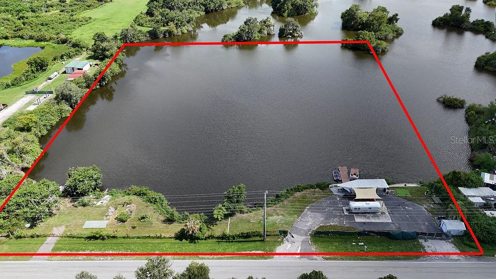 Discover the possibilities with this beautiful 5.98-acre waterfront property (note buildable acreage) on Pelican Lake, offering a rare opportunity to create your own lakefront retreat. With no HOA and zoning that allows for a site-built residence or manufactured home, this property is ready for your vision. Existing improvements include a working well, septic system, electric service, paved driveway, private boat dock, extended pavilion, detached one-car garage, and a paved building pad, providing a solid foundation for future plans. The property is fully fenced, and the owner currently resides on-site in an RV.

Enjoy peaceful lakefront living with direct access to Pelican Lake, whether you're planning to build your dream home, establish a weekend getaway, or create a private escape surrounded by nature. Of the 5.98 total acres, approximately 0.24 acre is buildable, with the remaining acreage consisting of lowlands that enhance the property's natural waterfront setting. If you've been searching for a unique waterfront parcel with utilities already in place and endless potential, this property is ready to make your vision a reality.

Highlights:

* 5.98-acre waterfront parcel on Pelican Lake
* Existing well, septic, and electric
* Private boat dock, extended pavilion, and detached one-car garage
* Paved driveway and existing paved building pad
* Fully fenced with no HOA
* Zoned for a site-built home or manufactured home