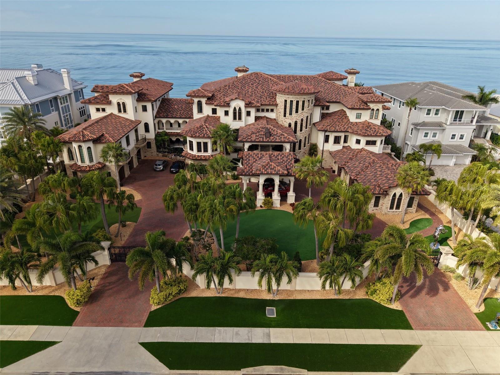 Welcome to Sandcastle on the Gulf! This one-of-a-kind Beachfront Estate embodies unparalleled luxury and resort-style living. This Mediterranean-inspired architectural masterpiece spans three lots and was built to the highest quality and design. This irreplaceable home showcases breathtaking Gulf views with 200 feet of private beachfront in the exclusive Town of Belleair Shores.
Outdoors, enjoy a spectacular resort-style pool with a lazy river and a fully equipped grill area featuring refrigeration and ice - ideal for entertaining. Inside, discover a bowling alley, adding a unique experience.
A temperature-controlled wine room and bar area complete with an ice maker, wine fridge, and kegerator elevate your hosting experience, while a cozy home theater offers the perfect space to unwind. The main kitchen and butler’s kitchen are outfitted with top-of-the-line appliances, designed for both functionality and style. For every day ease, the home includes four laundry rooms thoughtfully placed throughout. 
Wellness is redefined in the private gym, featuring a steam shower and sauna for complete relaxation. A separate 5,000+ square foot guest home with a private entrance provides comfort and privacy for your visiting friends and family. This is coastal living elevated to its highest form. With a price positioned more than $10 million below its estimated replacement cost, this offering is a rare opportunity to secure a legacy property and own a true Gulf-front Masterpiece at a compelling value. Seller welcomes creative offers, including the potential trade of residential, commercial, retail, or multi-family real estate as well as yachts.