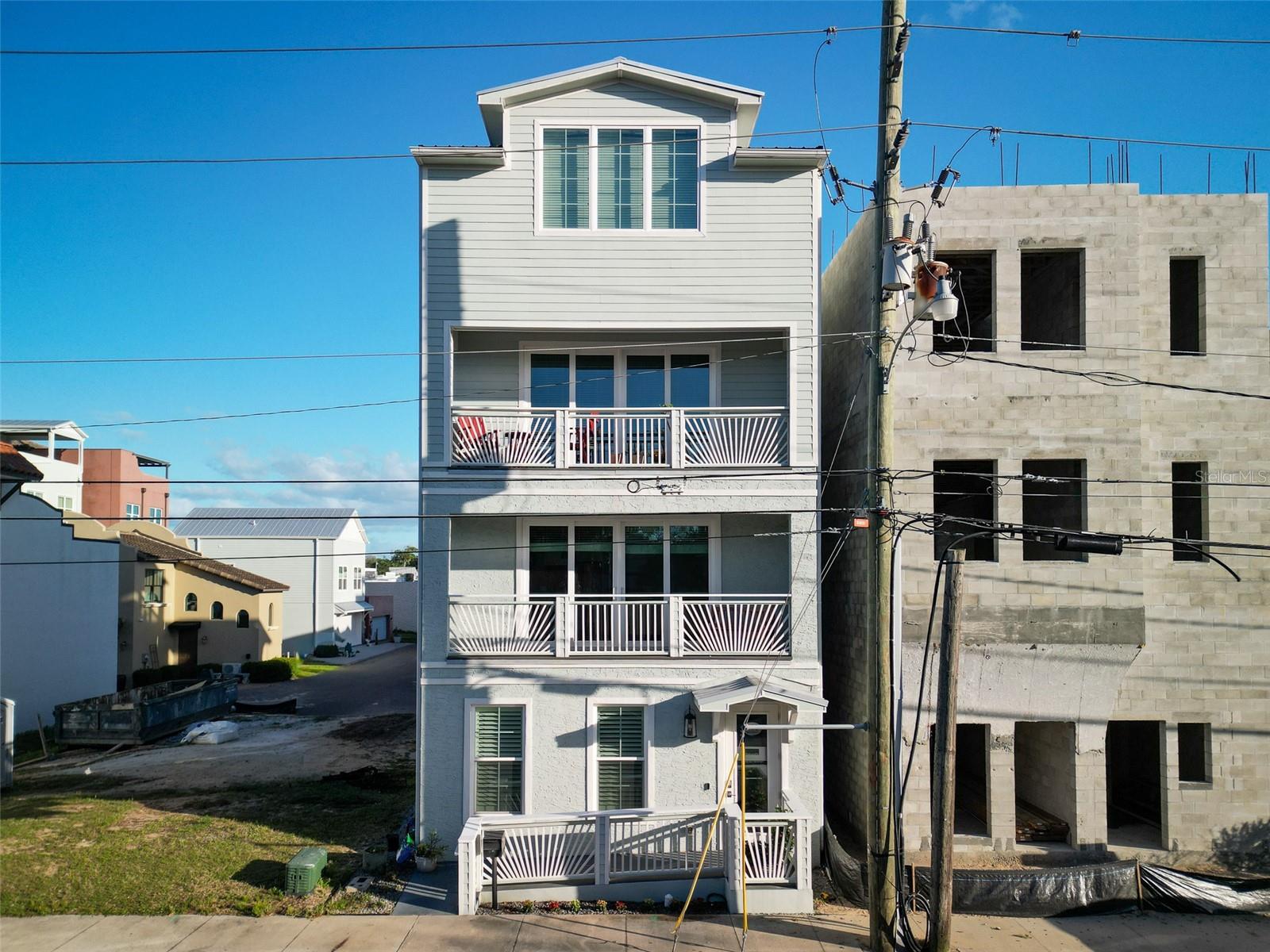 Unique multi-use property in a prime downtown New Smyrna Beach location. This versatile layout features commercial space on the first floor with residential living above, providing flexibility for owner-occupants, live/work use, or long-term income potential. The second and third floors include separate kitchen areas, making it well-suited for multi-generational living or extended family arrangements. Three spacious bedrooms each feature en suite baths and walk-in closets, with the top-floor bedroom designed as an open loft-style space. Enjoy the convenience of being just a short walk to Canal Streets dining, shopping, and entertainment. A rare property in a highly desirable location with multiple potential uses. All information deemed reliable but not guaranteed; buyer to verify. Listing Agent is Owner.