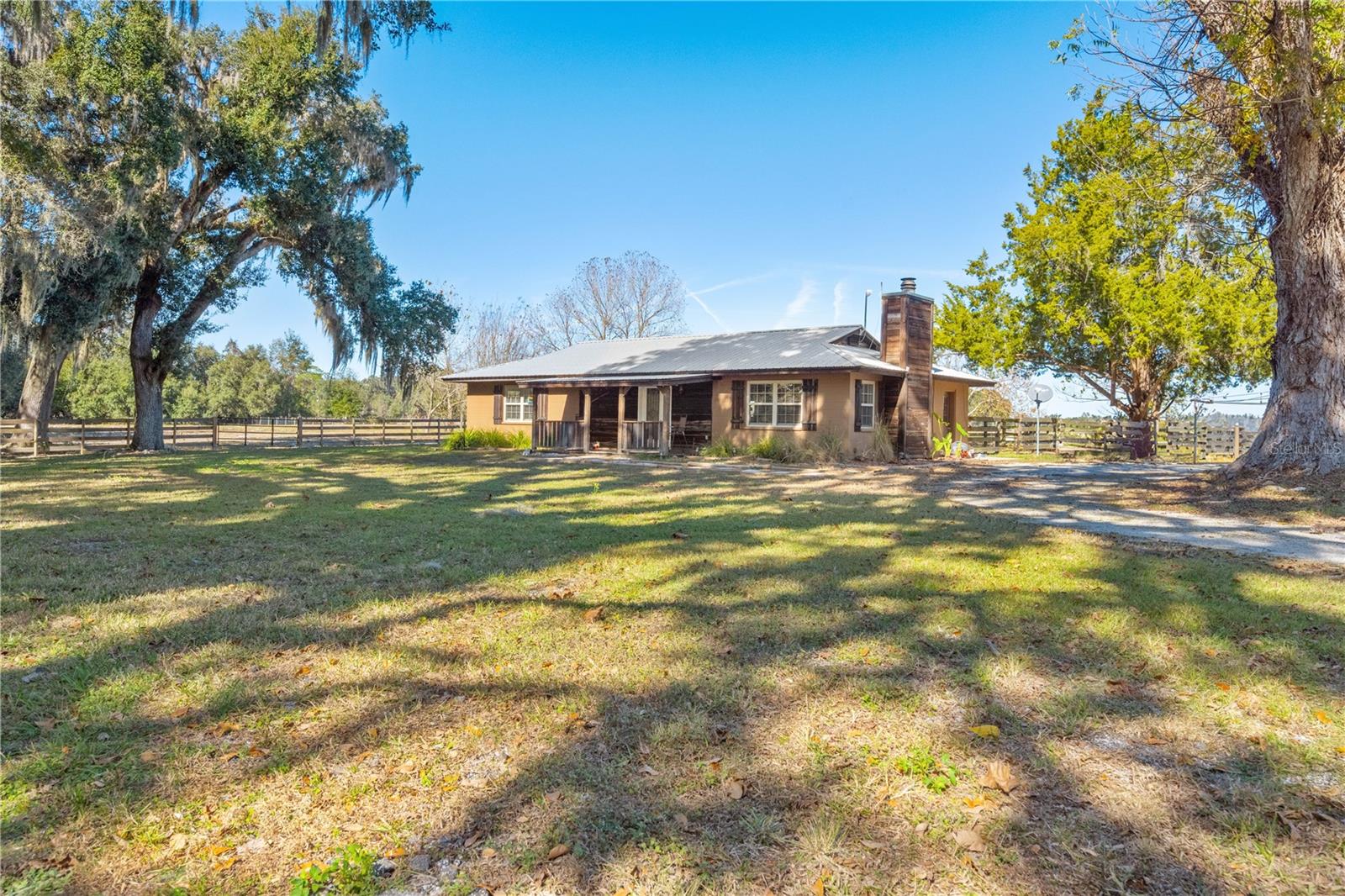 This nicely laid-out equestrian property offers a rare combination of functionality, comfort, and an outstanding location in a peaceful countryside setting. Situated on just over 10 acres, the farm is thoughtfully designed for efficiency and ease of use—ideal for serious horse enthusiasts or professionals. Offering scenic views of the surrounding land, mature trees, open fields, ponds, and consistant surrounding properties.

The property features a riding arena, a covered riding area, a 7-stall barn, and a hot walker, providing excellent infrastructure for training and daily care. A separate pole barn adds valuable additional storage or utility space.

A barn apartment and a separate cottage, both currently leased and income-producing, offer immediate revenue potential and flexibility for staff housing, guests, or future owner use.

The updated main home is warm and inviting, featuring a wood-burning fireplace, open floor plan and modern improvements throughout. A huge 30'x30' workshop with lean-tos provides ample space for equipment storage and could easily be converted into additional stalls, allowing for easy expansion of the equestrian operation.

The entire property is gated for privacy and security, and its prime location makes it a truly standout opportunity for a turnkey equestrian facility with built-in income.  

Conveniently located within easy distance to World Equestrian Center, HITS, Black Prong Equestrian Village, Goethe State Forest, as well as multiple trailheads.  Remote to Ocala, Gainesville, Chiefland, Dunnellon and Crystal River as well as the entire Nature Coast.  Come check it out and find your place in the Sun!