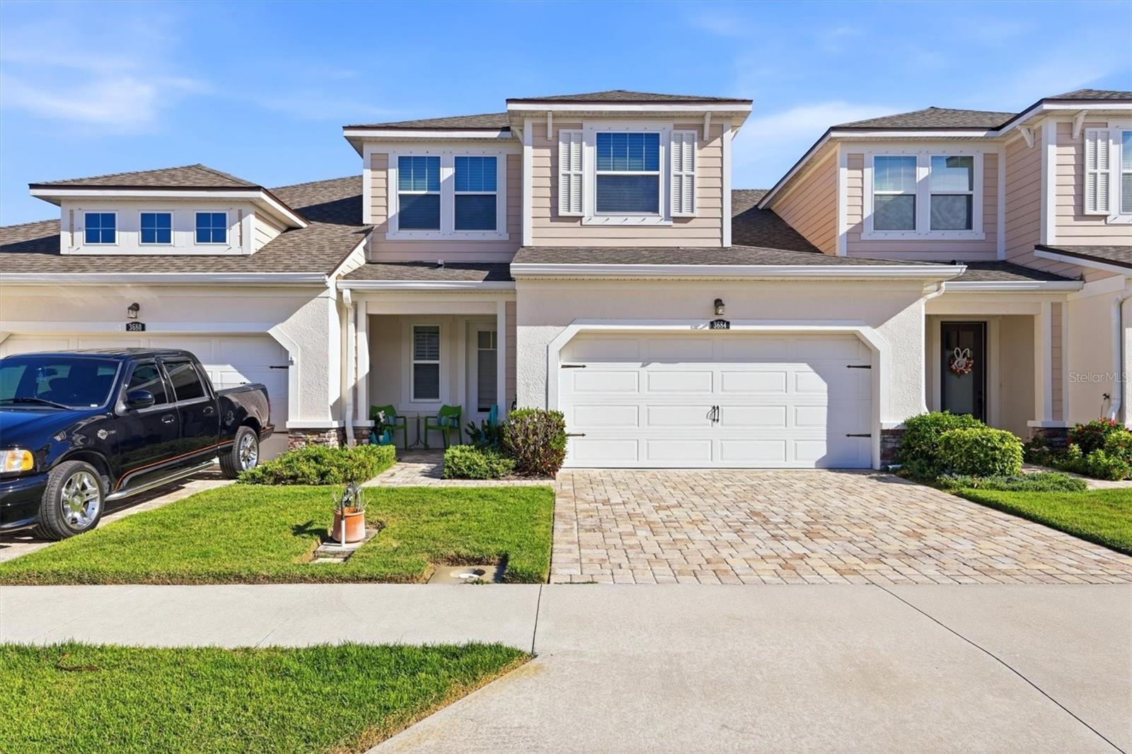 Location is everything and this exceptional townhome in Enclave at Forest Lakes delivers.  Ideally in the heart of Sarasota, this gated community offers unmatched convenience with two public golf courses nearby, direct access to the Legacy Trail just beyond the Webber Street gate, and seamless connectivity in every direction, north, south, east and west. Inside the community, residents enjoy a welcoming gathering area, resort-style pool and dog park, ideal for relaxation and an active lifestyle. Built in 2018, this residence stands out as one of Mattamy’s finest offerings, showcasing a range of thoughtful upgrades and refined finishes throughout. Engineered hardwood flooring adds warmth and durability underfoot, while the French Country–inspired kitchen features rich cabinetry with bronze accents, elegant granite countertops, a stacked stone backsplash, wall-mounted oven and microwave, and a sleek electric cooktop. Designed for everyday living and entertaining, the open layout includes a breakfast bar with seating for three, a spacious dining area accommodating up to six, and a comfortable living room that opens through sliding glass doors to a fully covered lanai, ideal for year-round enjoyment. Architectural details such as solid wood and wrought iron stair railings add character and sophistication. Upstairs, a versatile loft and additional flex space provide endless possibilities, whether used as a media room, home office, fitness area or creative studio. Two generously sized bedrooms offer comfort and privacy, complemented by a well-appointed bath with granite countertops, French Country cabinetry, and a tub/shower combination. The primary suite, conveniently on the main floor, is a retreat featuring crown molding, a spacious dual-sink vanity with extended granite countertop and an oversized walk-in closet with ample dressing space. In the garage is a new whole-house water purifying system by WaterExpress. This is more than just a home, it’s a lifestyle. Discover the comfort, quality and convenience waiting for you at Enclave at Forest Lakes.
