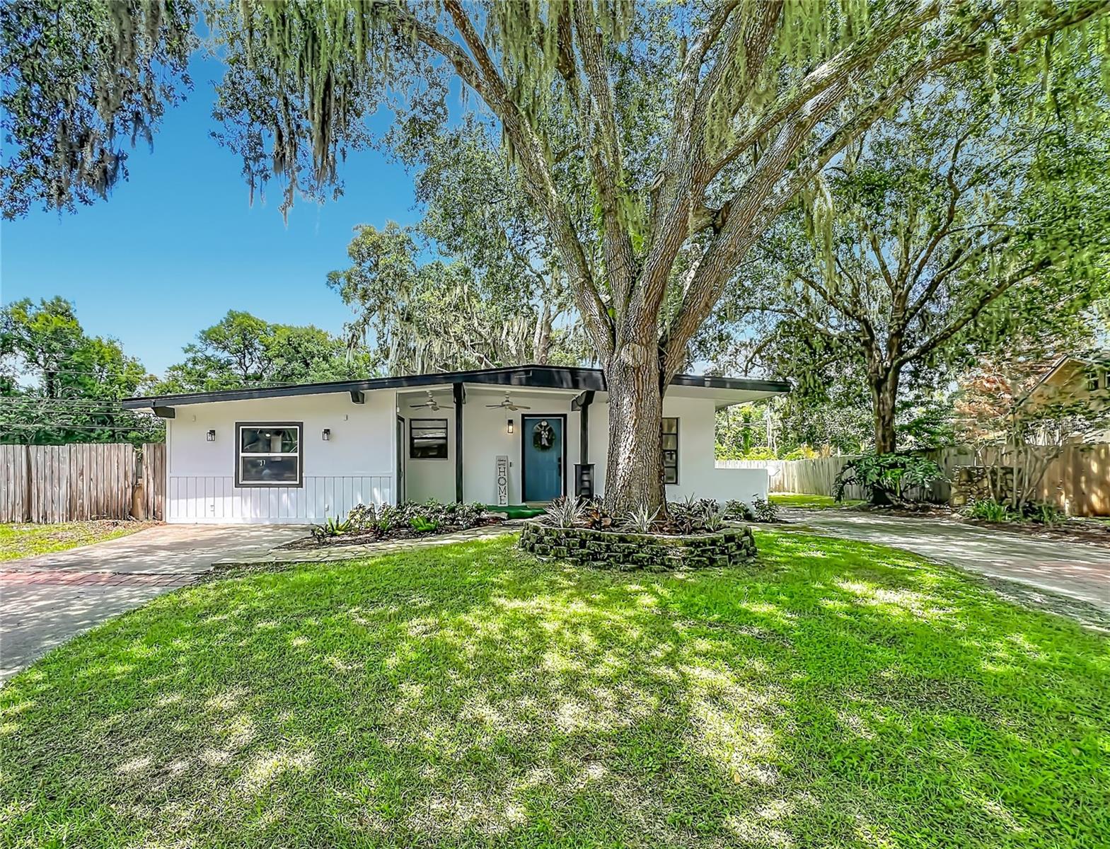 Completely Renovated 4-Bedroom Home on Over 1/3 Acre! Welcome home to this beautifully renovated 4-bedroom, 2-bath residence situated on an oversized more than 1/3-acre lot shaded by majestic oak trees. Thoughtfully updated throughout, this move-in ready home offers the perfect blend of modern style and comfortable living. Step inside to discover an open, light-filled floor plan featuring luxury vinyl plank flooring, fresh contemporary finishes, and a spacious living room centered around a cozy wood-burning fireplace. The spacious eat-in  kitchen is sure to impress with crisp white cabinetry, solid surface countertops, stainless steel appliances, and a farmhouse sink.  The split-bedroom layout provides privacy, while the generous primary suite and three additional bedrooms offer flexibility for family, guests, or a home office. Outside, enjoy the expansive fenced yard with plenty of room for entertaining, gardening, pets, or future additions such as a pool, workshop, or outdoor living space. Features include:  Wood-burning fireplace, Luxury vinyl plank flooring throughout, Modern lighting and fixtures and a spacious open floor plan.  Fenced yard on over 1/3 acre and NO HOA! Sprinkler system is on a well, so you will save some money on irrigation! Conveniently located near shopping, dining, schools, parks, and major roadways, this beautifully updated home offers space, style, and exceptional value.