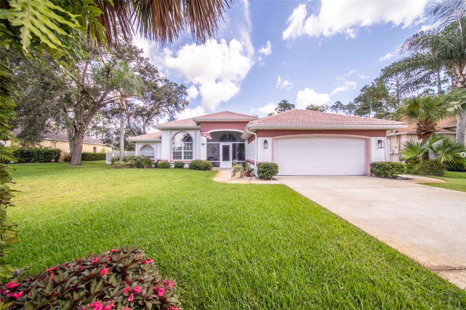Honey stop the car! You will not find another property like this in Palm Coast! Welcome to this beautifully maintained 3-bedroom, 3-bathroom pool home nestled on over half an acre of FULLY FENCED property, offering privacy, space, and a wide range of valuable upgrades. Backing up to the Cypress Knoll Golf Course, the home provides tranquil views and no rear neighbors, creating a peaceful and private retreat. Inside, you'll find a spacious split-bedroom layout with a well-appointed kitchen featuring granite countertops. The home is equipped with a 3-ton, 16 SEER A/C system installed in May 2018, complete with a UV Active Ionic Air Purifier to ensure year-round comfort and enhanced indoor air quality. All three full bathrooms provide functionality and comfort, and a new hot water heater was installed in 2024. Step outside to enjoy a beautiful pool with a Nano Saltwater System with a powerful 400,000 BTU pool/spa heater, perfect for relaxing or entertaining. The pool deck was updated in 2023 with long-lasting Shark Coating, and an outdoor shower adds extra convenience. The home is storm-ready with accordion hurricane shutters on the front and side windows and hurricane fabric covering all other openings. A 12kw dual-fuel whole home generator (gasoline/propane) offers peace of mind during power outages, and the property also currently has a termite bond for ongoing protection. The front and backyard are irrigated by a well-fed sprinkler system, keeping the landscape lush year-round. With its combination of thoughtful upgrades, serene golf course views, and a spacious lot, this move-in ready home offers the perfect blend of comfort, style, and functionality in a prime location. Red lines in photos show approximate property boundary lines and where new vinyl privacy fence was recently installed.