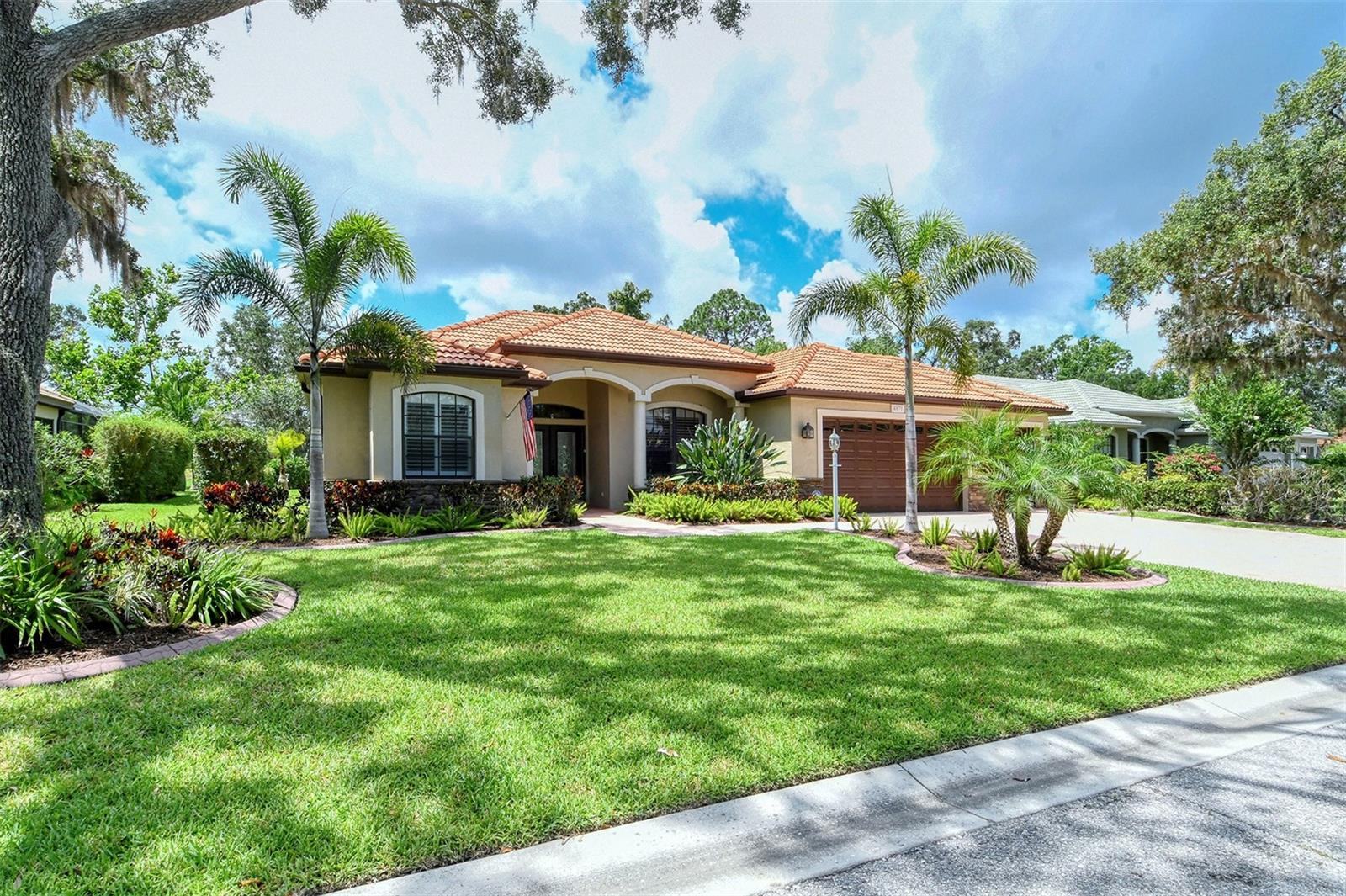 NATURE ABOUNDS in Secluded Oaks! This exceptional home features 4 bedrooms, 3 full bathrooms, 3-Car Garage and boasts one of the most private and exclusive lots in the neighborhood; with a coveted Southern Sun Exposure! The modern open floor plan and grand ceilings lead into a Gourmet Kitchen with granite counters, a newer Café Refrigerator. Natural gas is available. Hurricane Windows & Doors throughout.
You will never lack for entertainment with bountiful Wildlife to enjoy in your own backyard; imagine waking up with a 6 point buck grazing just beyond your lanai with the sandhill cranes passing-by just beyond him on the most beautiful lake in Sarasota! Generous private pool and spa with an upgraded pool pump, and heated. Location is not far from shopping, schools & a short distance to Siesta Key Beach, the #1 beach in U.S.A!  LOW HOA fees, No CDD’s.