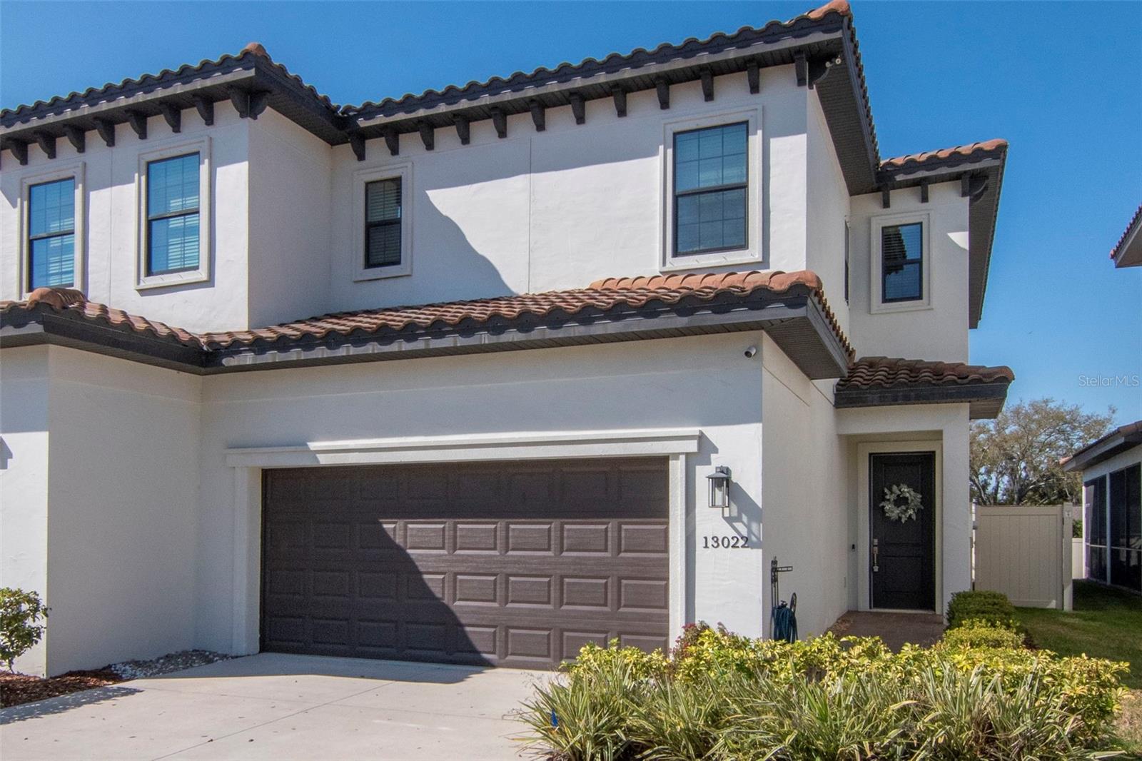 One or more photo(s) has been virtually staged. Situated within the gated community of Sanctuary at Carrollwood, this beautifully appointed Spanish/Mediterranean-style townhome blends timeless design with modern comfort. Built in 2019, the two-story residence showcases a bright, open-concept floor plan enhanced by soaring 10-foot ceilings, rich wood flooring, a neutral designer palette, and abundant storage throughout.
The gourmet kitchen is thoughtfully designed for both everyday living and effortless entertaining, featuring 42-inch cabinetry, quartz countertops, a glass tile backsplash, stainless steel appliances, dual pantries, and a generous island offering additional prep space and seating.
Upstairs, the private living quarters include a spacious primary suite, two guest bedrooms, a full guest bath, laundry room, and a versatile bonus nook ideal for a home office or reading space. The primary suite offers a generously sized bedroom, well-appointed bath, and a custom-designed walk-in closet tailored for optimal organization. Both guest bedrooms also feature walk-in closets with custom built-in shelving a rare and valuable upgrade.
Just off the great room, the covered patio provides a peaceful retreat overlooking the vinyl-fenced backyard perfect for morning coffee or unwinding at the end of the day. The downstairs HVAC was replaced in 2025 and the garage features an EV charger.
Ideally situated near the best of Carrollwood, residents enjoy convenient access to top-rated dining, shopping, and entertainment. Outdoor enthusiasts will appreciate being approximately one mile from Carrollwood Village Park, offering walking trails, a parkour course, dog park, skate park, splash pad, amphitheater, and more.
A refined, low-maintenance lifestyle in one of Carrollwood’s most desirable gated communities.