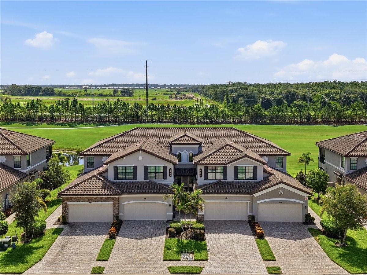 Experience luxury resort-style living in the highly sought-after Lakewood National Golf & Country Club. This beautifully appointed first-floor coach home offers the perfect combination of comfort, convenience, and breathtaking water and golf course views, all within one of Lakewood Ranch's premier gated golf communities. Featuring approximately 1,786 square feet of thoughtfully designed living space, this residence offers 3 spacious bedrooms, 2 bathrooms, and a 2-car garage. Beautiful diagonal tile flooring flows throughout the home, creating a seamless, elegant feel while enhancing the spacious open-concept design. The home is filled with natural light and showcases a beautifully appointed kitchen with granite countertops, stainless steel appliances, ample cabinetry, and a large center island that seamlessly flows into the dining and living areas—perfect for entertaining or everyday living. The true highlight of this home is the expansive screened lanai, where you'll enjoy picturesque views overlooking sparkling water and the manicured fairways. Whether you're sipping your morning coffee, watching golfers pass by, or taking in Southwest Florida's spectacular sunsets, this outdoor living space is sure to become your favorite retreat. Ownership includes a deeded golf membership, providing access to two championship Arnold Palmer-designed golf courses and an unmatched collection of resort-style amenities. Residents enjoy a stunning clubhouse with dining, resort-style pool with tiki bar, state-of-the-art fitness center, full-service spa, tennis courts, pickleball, bocce ball, satellite pools, and a vibrant social calendar featuring live entertainment, trivia nights, bingo, and countless community events throughout the year. Ideally located in the heart of Lakewood Ranch, you'll be just minutes from shopping, dining, entertainment, medical facilities, and the world-renowned Gulf Coast beaches. Whether you're looking for a full-time residence, seasonal getaway, or investment opportunity, this exceptional coach home offers the very best of the Florida country club lifestyle. Schedule your private showing today and discover why so many are proud to call Lakewood National home!