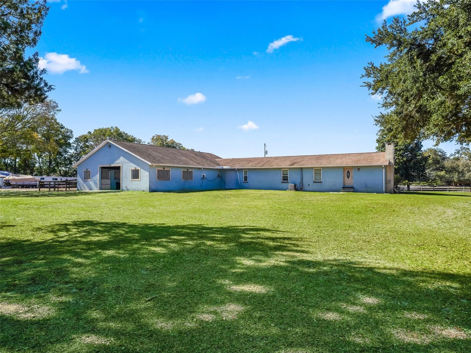 Wonderful 15.5 acre horse farm with an additional adjoining 15 acres with a house available as well. This 15.5 acre farm is less than 10 minutes to the HITS show grounds & 20 mins to the World Equestrian Center! The farm is equine ready with a gated entrance, updated 2-bedroom house, 6 stall concrete block center aisle barn, 12 paddocks with water & shelter in each, 2 barn apartments, 2, 50-amp rv hook ups & a large pole barn with electric & water. The well-designed barn was built in 2012 with many high-end amenities including 6, 12’ x 12’ stalls with the comfort stall systems & auto waters, 2 wash stalls with hot water, roll up hurricane doors, grooming stall, & a tack room & feed room. There is also a separate hay room. There are two barn apartments- one studio & a 1 bedroom/ 1 bathroom. The 2-bedroom house is also concrete block construction, has 2 full bathrooms, over-sized primary bedroom walk in closet, has been updated with tile flooring throughout, & kitchen was updated with newer soft close cabinets & stone counter tops. The property has 2 wells that are connected w/ water softener system & is easy to see!