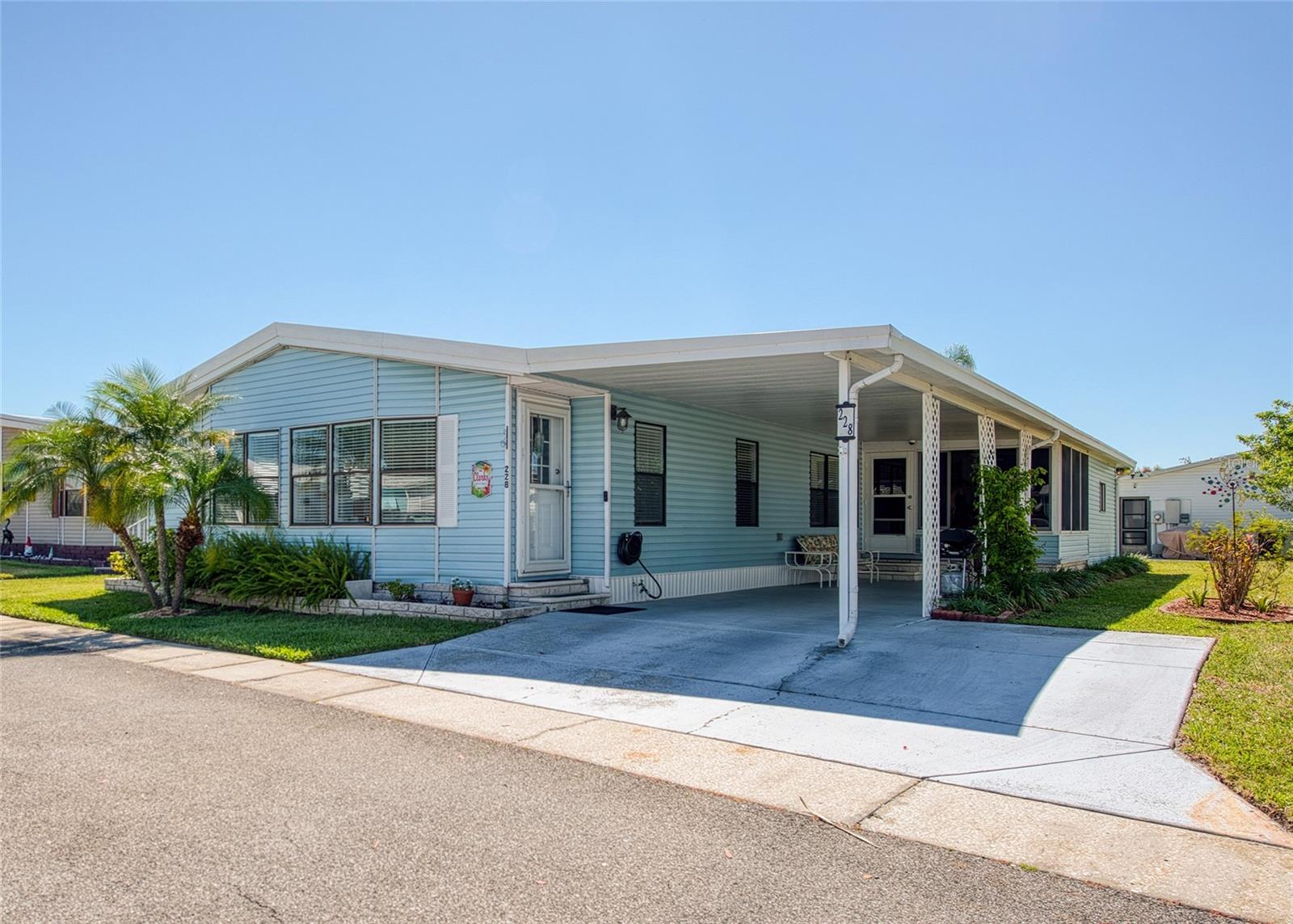 Discover this 1,686 sq ft 1991 Jacobsen retirement home, featuring a new roof (2025), new A/C (2024), new water heater (2026) and a new Rainsoft water softener in 2020. The layout offers both comfort and flexibility for relaxing or entertaining. Step into the oversized living room featuring soaring cathedral ceilings and an abundance of windows that fill the space with natural light, creating a welcoming atmosphere. The large chef’s kitchen is a standout, with ample cabinetry for storage, a convenient pantry, and generous countertops perfect for meal preparation. A separate dining room makes everyday meals and entertaining easy and elegant. The expansive family room, measuring 27x15, is ideal for a large screen TV and gathering with friends and family. Retreat to the updated primary suite, which boasts new, modern bath cabinet with double sinks for added style and functionality. The indoor laundry room is equipped with custom built-in cabinets, a desk, and countertop space—perfect for folding clothes or tackling craft projects. The 11x11 Florida room sits behind the carport with acrylic windows. The utility room can be used for a workshop or bike storage. The vibrant clubhouse serves as the lively centerpiece of the community, offering a welcoming space for residents to connect and unwind. Enjoy a wide range of amenities, including a pool table, shuffleboard, bocce ball court, and a luxurious heated pool and spa. Monthly events and regular activities such as bingo, card games, and line dancing create endless opportunities for fun and socializing, ensuring you stay active and engaged. Navigating the neighborhood is easy and enjoyable thanks to golf cart-friendly streets. With HOA fees at just $70 per month, you will appreciate affordable, worry-free living in a meticulously maintained environment. This pet-friendly community welcomes one pet of any size, and a second pet is allowed with an emotional support letter from your doctor. Ownership includes the land—no lot rent—giving you peace of mind and long-term value. Everyday conveniences are right at your doorstep, with AMC Theatres, Bealls, Marshalls, Ulta Beauty, PetSmart, Five Below, and Dollar Store just across the street. Savor the variety of dining options nearby, including Shaker & Peel, Craft Street Kitchen, Mandolas, Country Pizza Italian Grill, and Eves Family Restaurant. Major retailers like Super Walmart and Publix, as well as Countryside Hospital, are only about 10 minutes away. For outdoor enthusiasts, the breathtaking beaches of Honeymoon Island and Caladesi State Park are approximately ten miles from home, offering the perfect escape for sun and sand. A scenic biking and walking trail along the canal provide easy access from within the community, inviting you to enjoy nature at your own pace. This remarkable home combines comfort, practicality, and style, making it a wonderful place for your next chapter. Room sizes are approximate.