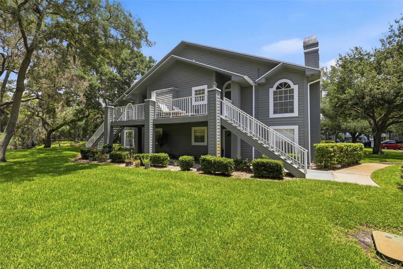Rare top-floor end unit in one of Raintree Village's most desirable locations. Enjoy beautiful lake views from the front porch and entry, framed by mature oak trees and lush Florida landscaping.

Inside, the open floor plan features vaulted ceilings, a wood-burning fireplace, and abundant natural light throughout. The flexible layout offers two bedrooms plus a third room with French doors that can easily function as a home office, guest room, or additional bedroom. Updated wood flooring, lighting, and ceiling fans add to the home's appeal.

Enjoy both a spacious open patio and a screened lanai, providing multiple outdoor living spaces to relax and entertain.

The monthly HOA fee covers exterior maintenance, water, sewer, trash, cable, and access to Raintree Village's extensive amenities, including multiple pools, playgrounds, walking paths, and beautifully maintained grounds.

Conveniently located near USF, Moffitt, AdventHealth, shopping, dining, and major interstate access, this home offers low-maintenance living in the heart of Temple Terrace.