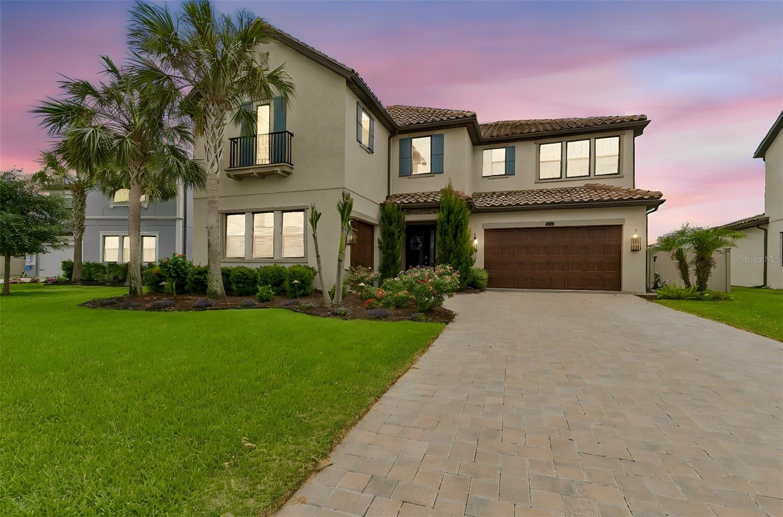 Welcome to your new home. In this stunning Estancia at Wiregrass Ranch Estate home in the highly coveted Revello section, serene water views, a sparkling pool, and a private owner’s balcony come together to create an exceptional lifestyle. Set on a premium pond-front homesite near the end of a quiet cul-de-sac in Estancia’s exclusive gated enclave, this remarkable residence offers privacy, elegance, and resort-style living today’s discerning buyers seek. 
Your entry into this stunning home begins with frosted glass double entry doors that open to a dramatic foyer highlighted by a stunning designer chandelier and beautiful luxury design throughout. Just off the entry is a separate private executive office with French doors providing an ideal work-from-home environment, while the formal dining room creates an elegant setting for dinner parties, family gatherings and memorable occasions. 
The gourmet kitchen is designed for both entertaining and everyday living, featuring an oversized island, gas cooktop, double wall ovens, dedicated coffee and beverage station, walk-in pantry, eat in dining space and abundant cabinetry. The kitchen opens seamlessly to the very spacious family room, anchored by a warm and inviting centerpiece fireplace and triple sliding glass doors that showcase the stunning pool and pond views.
Upstairs, there is a large bonus room, perfect for a media room, fitness center or anything that fits your lifestyle. While the luxurious owner's retreat suite features a private balcony for enjoying morning coffee or sunset views overlooking the water there is also a massive walk-in closet, spa-inspired bath with dual vanities, soaking tub, oversized walk thru shower with dual showerheads, and a sitting alcove. Three generous sized additional bedrooms, three full baths, and a well-appointed laundry room with sink, folding counter, and extensive upper and lower cabinetry complete the second floor.
Downstairs you will find a tucked away separate guest bedroom and a full bathroom perfect for visiting guests or multigenerational living
Step outside to your private backyard featuring an inviting poolside oasis with a refreshing oversized saltwater pool framed by a travertine deck that exudes timeless elegance and natural warmth, a fully fenced yard, and serene pond views—just in time to enjoy this summer and perfect for relaxing or entertaining year-round. SHOWCASING OVER $169,000 IN PREMIUM UPGRADES, every detail of this home has been thoughtfully curated to elevate both its beauty and functionality. 
Residents of Estancia enjoy a resort-style lifestyle with a beautifully appointed community clubhouse, theme park-inspired pool, fitness center, tennis/pickleball courts, walking trails, parks, and a vibrant calendar of social events and activities. Conveniently located near premier shopping, dining, top-rated schools, medical facilities, and major highways, this exceptional home offers luxury living in one of Wesley Chapel's most sought-after communities. Don’t miss this exceptional pool residence with its 5 bedrooms + 4 full baths + Separate Office + Separate Bonus room. So meticulous and pristine, homes this nice do not last long, schedule your private tour today. Don’t forget to ask about lender incentives also available for this home.