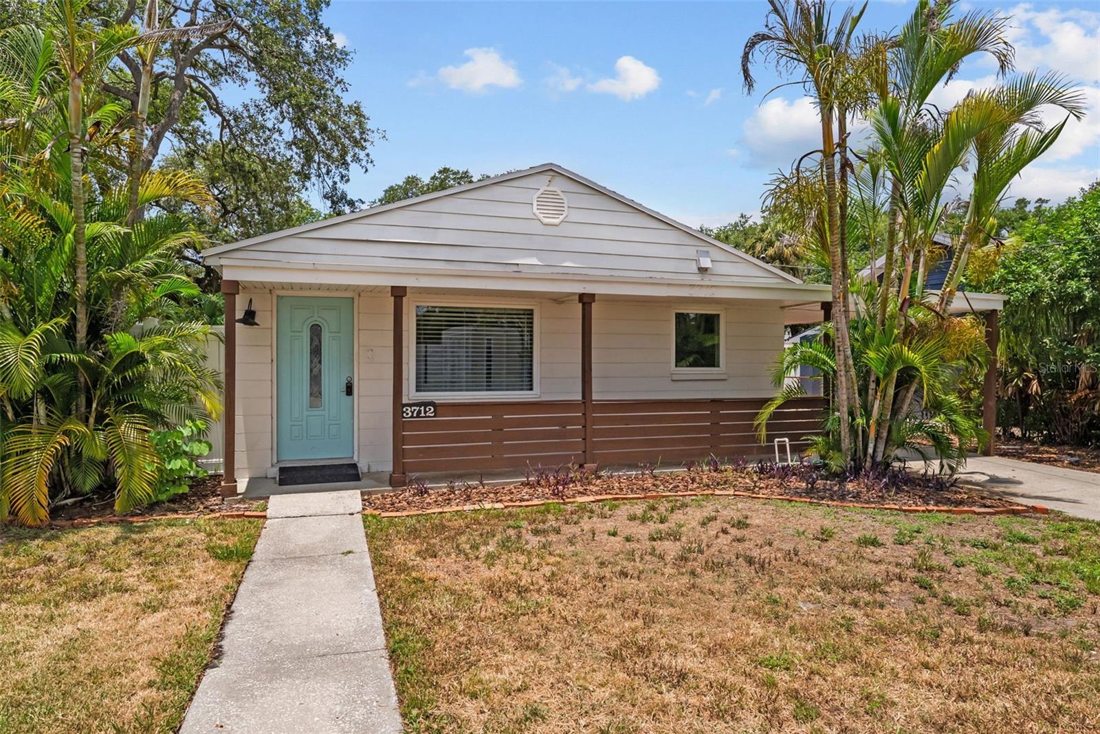 This charming block home features a 3-bedroom, 1-bath main house with 1,095 sq ft of living space, plus a detached 305 sq ft block in-law suite/studio. Located directly across from a full-size park with two baseball fields, basketball courts, and the Taylor Art Studio, this gem offers both convenience and lifestyle. You can park in the front carport or access additional parking via the rear alley leading to a second carport. Designed with storage in mind, the home includes built-in cabinets and multiple pantries throughout. There are too many custom features to list—from the oversized bathtub to a dedicated vanity area complete with an electrical outlet for your mirror. Just eight blocks north of the Riverwalk, the home is centrally located with quick access to I-275, I-4, Downtown, and only 12 minutes from the airport. If you love the outdoors and want to be close to everything, this is the one!