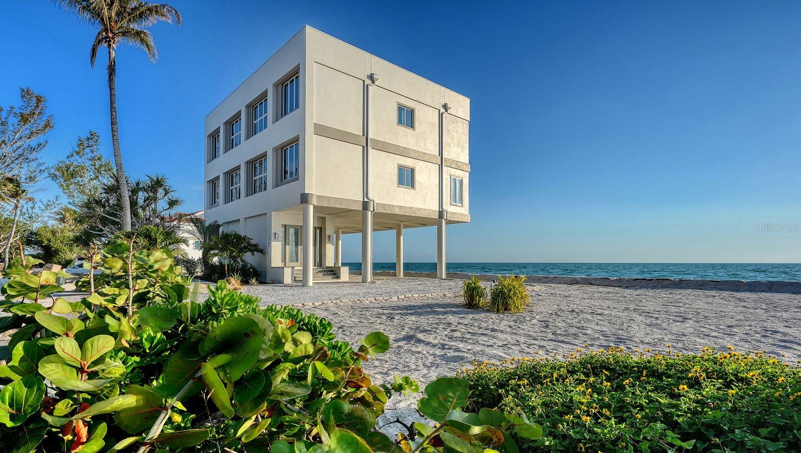One or more photo(s) has been virtually staged. Experience the art of beachfront living in this exceptional 4-bedroom, 4-bath Gulf-front residence, where sweeping water views and unforgettable sunsets take center stage. Spanning three thoughtfully designed levels, this coastal retreat offers a rare blend of refined comfort and effortless elegance. Walls of glass frame the Gulf from nearly every vantage point, filling the home with natural light and showcasing breathtaking vistas that evolve throughout the day. A private elevator provides seamless access to all floors, while expansive living spaces invite both relaxed everyday living and refined entertaining. Recent enhancements—including impact windows and sliders, four updated HVAC systems, and a new water system—ensure peace of mind while complementing the home’s modern coastal aesthetic. The guest bathrooms have also been tastefully updated with fresh, contemporary finishes, offering a polished and comfortable experience for family and visitors alike. Step outside to multiple outdoor living areas designed to capture the essence of coastal living. The rooftop terrace is a true showpiece, complete with a private jacuzzi—an idyllic setting to unwind under the stars or take in spectacular sunset views over the Gulf. With direct beach access just beyond your door, every day begins and ends with the soothing rhythm of the waves. Perfectly positioned on Blind Pass Road, this home offers both privacy and proximity to the charm of Siesta Key’s vibrant coastal lifestyle. This is more than a home—it’s a front-row seat to the Gulf, where every day feels like a getaway.