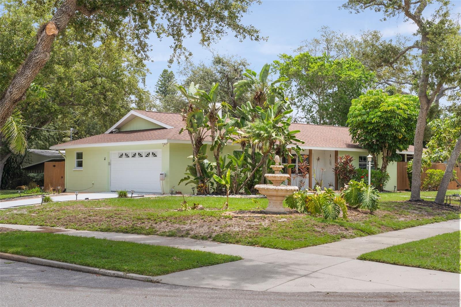 Welcome to your own private slice of paradise in the heart of Whitfield Estates. Perfectly positioned on a beautifully landscaped corner lot, this impeccably updated 3-bedroom, 2-bath residence is being offered completely turnkey furnished, making it truly move-in or rental ready from day one.

Step inside to a light filled, open concept floor plan where coastal charm meets modern design. Luxury vinyl plank flooring flows throughout the home, while the stunning chef’s kitchen features white shaker cabinetry, stainless steel appliances, a farmhouse sink, gorgeous countertops, and an oversized island perfect for casual dining or gathering with family and friends. The spacious living room is anchored by a beautiful stone fireplace with custom built-in shelving, creating a warm and inviting space that’s equally suited for relaxing evenings or entertaining guests.

The Florida lifestyle continues outdoors with a private screened lanai featuring an in-ground spa, while the fenced backyard offers lush tropical landscaping, peaceful sitting areas, and even a raised herb garden, your own secluded oasis for morning coffee or evening cocktails.

Designed for worry-free ownership, this home has been extensively updated with a new roof, updated windows, newer A/C and electrical panel, and quality finishes throughout. Currently operating as a successful Airbnb, the property also offers excellent investment potential thanks to nightly rental allowances, making it ideal as a primary residence, seasonal getaway, or income-producing vacation rental.

Located just minutes from Sarasota Bay, downtown Sarasota, SRQ Airport, IMG Academy, world-famous Gulf beaches, waterfront dining, shopping, and entertainment, you’ll enjoy the convenience of one of Sarasota’s most desirable neighborhoods. Around the corner, Sara Bay Marina offers easy access to boat slips and dry storage. While Whitfield Estates continues to be one of Sarasota’s hidden gems with no mandatory HOA or CDD fees. Residents also have the option to join the neighborhood association for just $40 annually, which includes culinary membership privileges at the prestigious Sara Bay Country Club.

Whether you’re searching for a move-in-ready home, a winter retreat, or a proven investment property, 7311 Broughton Street delivers the perfect combination of style, flexibility, and effortless Florida living.