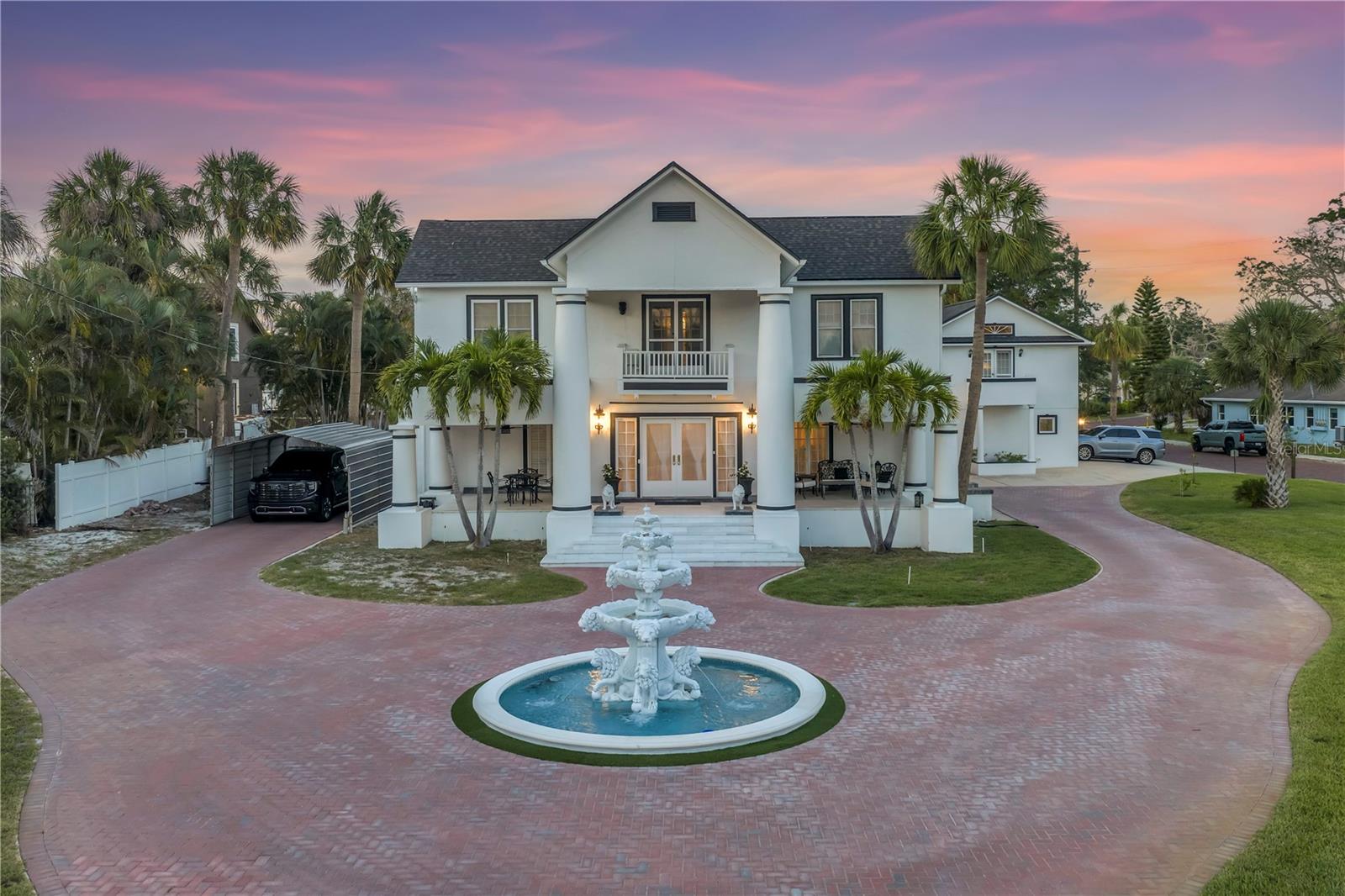 Modern updates within an iconic historic Pinellas estate! Enjoy almost 3/4 acre lot with all the charm and modern amenities while living the Florida lifestyle. All the historic charm without historic-house headaches; recent major updating already done for you, while restoring & caring for the original history and hardwood flooring. Rest assured your enchanting estate is ready for you to simply enjoy; new duct work, new electrical panels, new natural gas hooked in (including a spot for a whole house generator), new wiring, new plumbing, new HVAC systems that have the outdoor systems raised for peace of mind, new outdoor lighting and automated smart home features, newer roof (2020), new pool & spa equipment and solar. This estate has it all including high ceilings, a resort pool with zero entry & spa, outdoor kitchen, massive yard large enough for a playset, trampoline, dog run, while still having room for you to play and host chickens (chicken coop-house stays with the property)! Light abounds when you step in the French entry doors into the vestibule foyer, which has hosted game nights. Then saunter into the entrance hall with original stained-glass cover for its wood burning fireplace & antique candelabras, which has seen over 100 years’ worth of whimsical Halloween & Christmas settings, and countless parties. This 4-bedroom, 3 full/2 half bath home is truly a means for the whole family to enjoy their space. Plenty of parking within the majestic new (2023) front brick roundabout, dignified fountain, and custom Turkish marble entryway. The detached 3 car garage (with storage closet and built-in workspace) has an upstairs casita; 1bedroom/1bathroom with living & dining room combo, full kitchen, laundry, and has its own meter and address (and new water heater) – so you even have income property potential! Main has 3 upstairs bedrooms and two full bathrooms. There is a bonus room off the master that is currently a queen's closet & boudoir, but could be a nursery. Downstairs has two half bathrooms (one large enough for a shower to be installed). The guest bedroom, known in history as 'the men's parlor', is really a large flex space with gorgeous glass privacy doors, wood built-ins for office & closet needs. The formal living room/ladies parlor, is the perfect place for music practice and holiday parties. No shortage of storage in this estate; there are over 15 closets, a laundry room, and a climate-controlled workshop & storage space off the family room. For those cool evenings, there’s a wood burning fireplace (with gas hook up) in the massive family room; with enough space for pool table, large couch, and additional gaming & seating. Gorgeous wood beams & durable tile make the family room a fantastic space for gathering; a large wet bar perfect for entertaining and a closet space which can hold an additional fridge and pantry. The eat in kitchen is a chef's dream with large natural gas cooktop, matching commercial refrigerator & freezer, wine fridge, and walk-in pantry. The covered patio on the front of the home is the perfect spot for morning coffee & eating al fresco, there are even fruit bearing trees! The Spring Bayou is just steps from your front door; enjoy the water view yearly “Diving for the Cross” in Epiphany City. This one-of-a-kind estate is the perfect place to plant your roots and grow in the Florida sunshine! A few minutes to Sunset Beach, Fred Howard Park & Tarpon Springs Yacht Club.