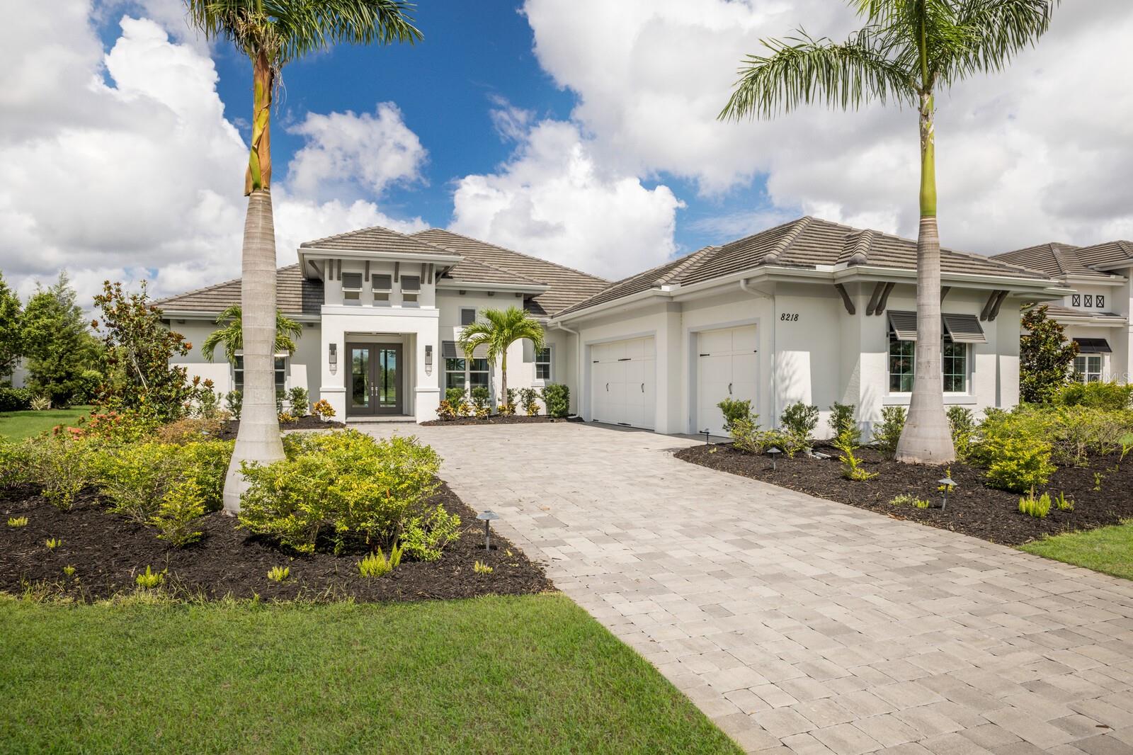 Experience sunsets over the lake from this Sterling III residence inside the exclusive gated community of The Lake Club in Lakewood Ranch. Encompassing 3,829 square feet of open one-story living, this custom Stock Home built in 2020 boasts generously sized indoor and outdoor spaces, volume ceilings, stylish finishes, and, of course, IMPACT windows/doors/sliders. 

An expansive outdoor retreat elevates the Florida living experience with a panoramic screened lanai, extensive open and under cover spaces grounded with pavers, fully loaded summer kitchen with even a pizza oven, PebbleTec heated saltwater pool/spa with sun shelf, fireplace, and a serene lake view with sunsets delivered nightly. 

Ten foot impact glass sliders seamlessly connect the outdoor oasis to a luxuriantly large great room, dining area and gourmet kitchen with sumptuous luxury plan vinyl crowned with soaring ceilings creating an open continuity of space. The kitchen further accentuates with white wood cabinetry, quartz counters, stainless steel appliances, and walk-in pantry. 

Relax and unwind in the owner’s quarters positioned on a private wing, offering double tray ceilings, large scale windows, direct lanai access, wood flooring, two oversized walk-in closets, and an appointed spa-like bath with two vanity stations , an oversized shower, large soaking tub, and separate water closet. Family and overnight guests will appreciate the three additional guest suites, all generous in size, all with walk-in closets, two offer ensuite full baths, while the third guest room is just off the home’s fourth full bath. 

An impressive club room directly off lanai beckons for entertaining with glorious views beyond, plus the residence delivers an impressive office behind double-entry doors just off the entry foyer. Other notable highlights of this all-encompassing 5,963 total square foot residence includes a brilliantly finished laundry room, a pool with auto-fill and auto-drain, all impact windows and doors, and an oversized three car garage with electric car charging station. 

This newer and modern offering is the pinnacle of luxury living in The Lake Club, where residents enjoy access to a wealth of amenities, including two resort-style heated pools, Grande Clubhouse with fine dining and bar area, a fitness center, spa, tennis courts, pickleball, a playground, dog park, and services of a full-time concierge and activities director.