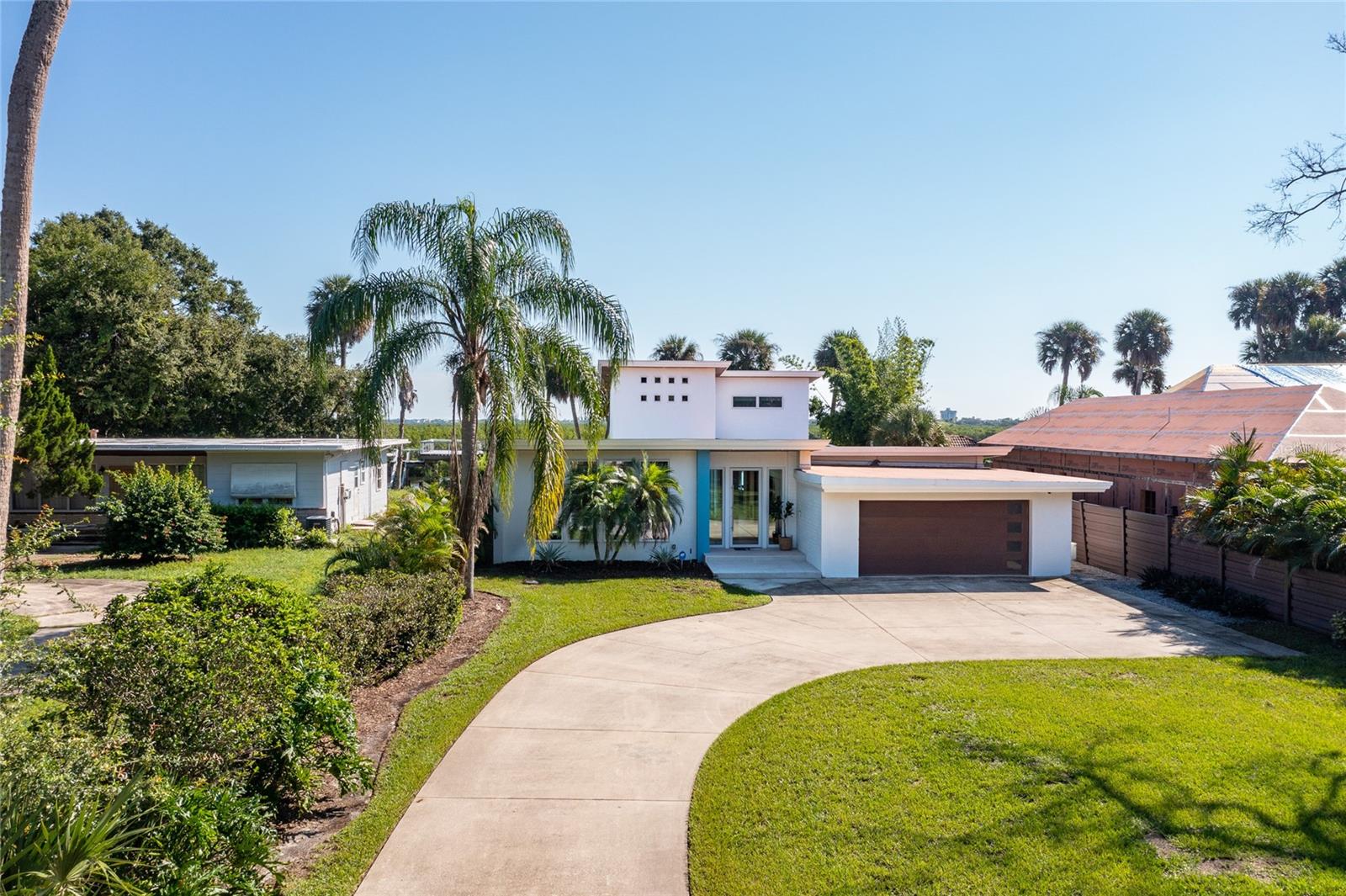Welcome to 705 Faulkner St, located in the heart of the Historic Arts District in New Smyrna Beach. Step into a gallery of awe-inspiring views and experience the epitome of luxury living. This exquisite mid-century modern home offers unparalleled intercoastal access and boasts 84' of pristine river frontage, complete with a boat house and 10,000lb lift. ( additional floating dock for kayak launch)
The home features three generously sized bedrooms, each with its own unique charm and En-suite bath.
An additional half bath and dedicated office provide ample space and privacy for family and guests.
Striking Design, meticulously renovated to maintain mid-century modern elegance, the home seamlessly blends classic architecture with contemporary upgrades, creating a timeless yet modern aesthetic. The kitchen is a chef's dream, outfitted with top-of-the-line appliances from Gaggenau, Miele, Sub-Zero, and True. Custom cabinetry, reminiscent of high-end yacht interiors, is paired with the sophistication and folly of Sasso & Blum hardware, for a touch of maritime luxury. The Artistic Interior has custom built- in furnishings which complements a minimalistic lifestyle. The unique ambiance of a feature wall created by reclaimed Florida hickory, brings natural beauty and warmth into the living space. Panoramic Views from the custom Euro-wall sliding doors provide unobstructed views of the intercoastal waters, enhancing the connection between indoor and outdoor living.
The elegant outdoor living spaces pull together the beautifully landscaped outdoors, highlighting features of Italian porcelain pavers, an outdoor kitchen with granite countertops, and multiple lounging and alfresco dining spaces, perfect for entertaining or relaxing.
The luxurious Pool and Spa with an infinity-edge, heated & saltwater, are designed for ultimate relaxation, complete with lighted bubblers, framed outdoor mote and a striking waterfall wall feature renders you silent just basking in your private luxury resort. Located just five minutes from the beach and within walking distance to the vibrant Canal Street Historic Arts District, this property combines the convenience of coastal metropolitan living with the tranquility and spoils of waterfront ventures. Book your private showing today!