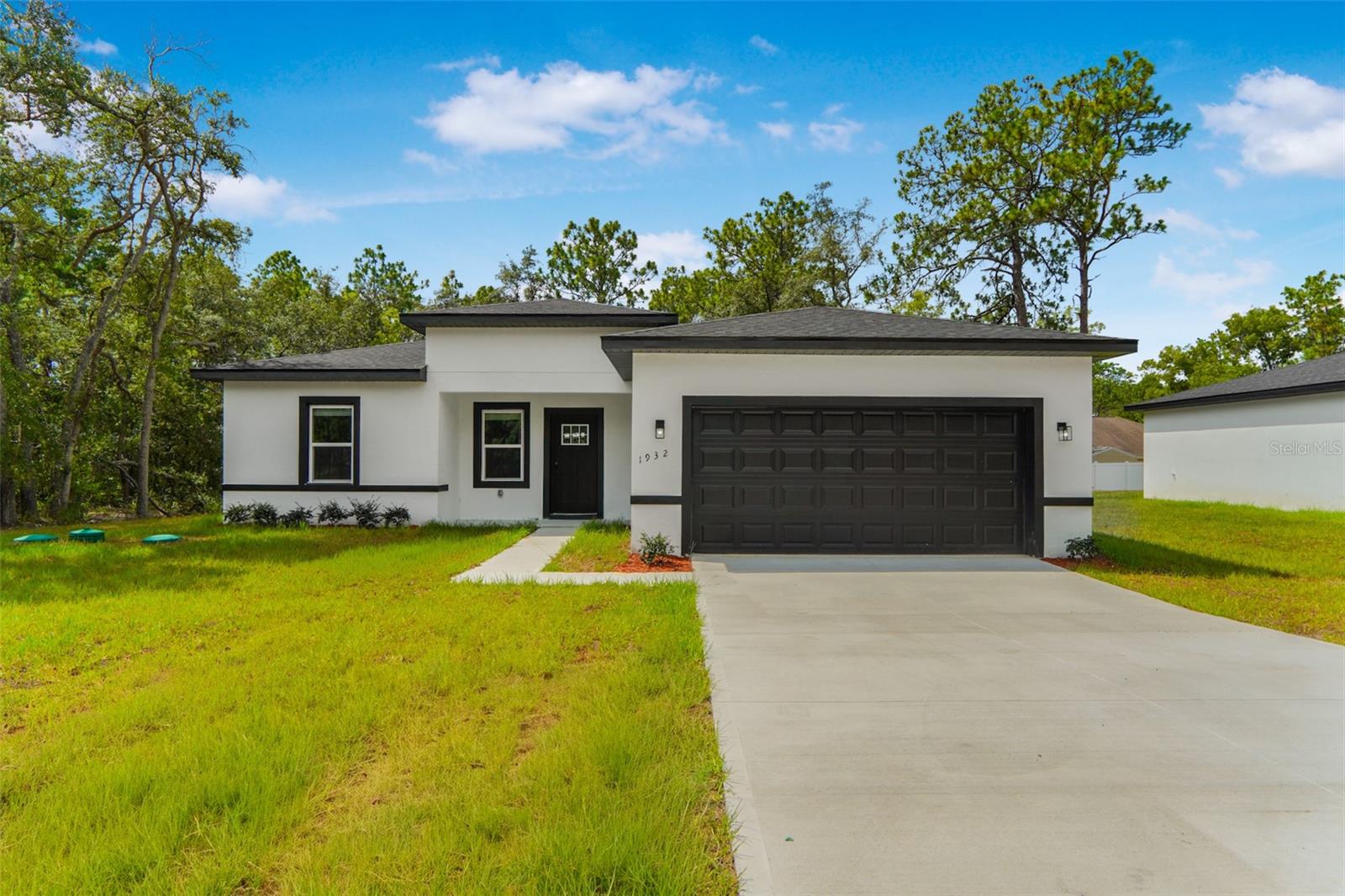 Brand-new 2026 build in Citrus Springs, never lived in and ready for its first owner. This single-story 4-bed/2-bath offers 1,833 sq ft of bright, open-concept living under a hip roof: porcelain tile and SPC luxury-vinyl flooring, a kitchen island wrapped in Luna Pearl granite with a waterfall edge, solid-wood shaker cabinets, a freestanding soaking tub, and brand-new stainless Whirlpool appliances. Block-and-stucco construction, shingle roof, 2-car garage, paver driveway, a covered 19x8 rear patio, and a 0.22-acre lot — plus no HOA, no CDD, and a 1-year builder warranty for real peace of mind. Minutes from the Rainbow River and Rainbow Springs State Park, the Withlacoochee State Trail, and Citrus Springs golf, with Ocala and the World Equestrian Center roughly 35 minutes away. USDA-eligible — qualified buyers may finance total purchase price with zero down. A rare shot at a move-in-ready new home with nothing down. Be the first to call it home.