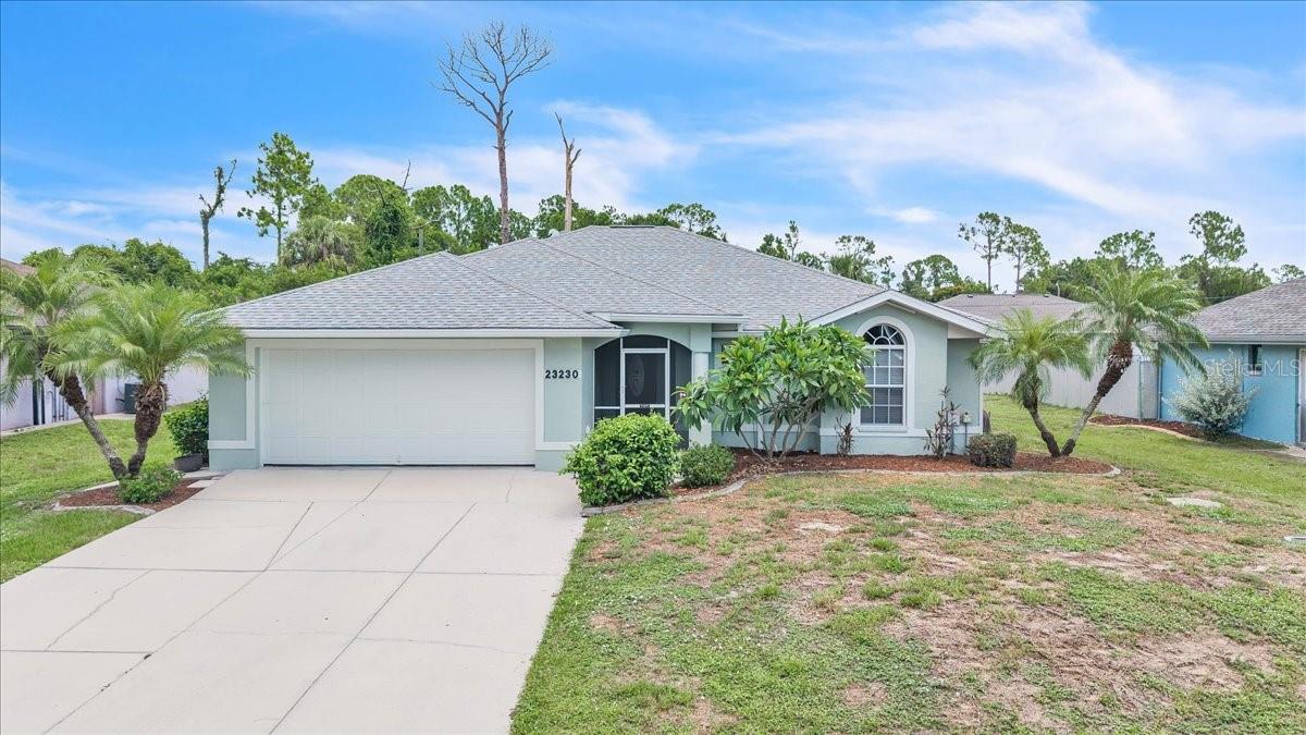 Welcome to this beautiful 3-bedroom, 2-bath home offering 2,001 square feet of comfortable living space with an attached 2-car garage. Located in a quiet neighborhood surrounded by tropical landscaping, this home offers the perfect combination of comfort, functionality, and the relaxed Florida lifestyle. The spacious driveway provides ample parking, while the attached garage offers additional storage and everyday convenience. A new roof installed in 2022 provides added peace of mind for years to come. A screened-in front entry welcomes you into this thoughtfully designed home. Inside, discover a spacious open-concept great room and dining area, perfect for both everyday living and entertaining. Tile flooring flows throughout the main living areas, complemented by a tray ceiling with crown molding, recessed lighting, and an oversized ceiling fan. Sliding glass doors bring in abundant natural light and lead to the covered lanai, creating the ideal indoor-outdoor Florida living experience. Built-in shelving and architectural details add both character and functionality to this impressive central living space. The spacious kitchen is the heart of the home, offering beautiful wood cabinetry, durable Corian countertops, a cooktop with overhead vent hood, built-in wall oven and microwave, stainless-steel refrigerator and dishwasher, and a convenient pantry closet. Plenty of counter space and storage make meal preparation easy, while the breakfast bar overlooking the great room allows the chef to stay connected with family and guests. A built-in desk area provides the perfect spot for a home office. The expansive primary suite offers a peaceful retreat with plenty of room for oversized furnishings. A tray ceiling with recessed lighting, modern ceiling fan, and custom built-in wall unit add style and functionality to the space. The private en-suite bathroom features a large dual-sink vanity with abundant cabinet storage, a relaxing jetted soaking tub, and a spacious walk-in shower accented with glass block details that allow natural light while maintaining privacy. On the opposite side of the home, two generously sized guest bedrooms provide privacy and comfort for family or visitors. Both bedrooms feature built-in closets and plush carpeting, which is also found in the primary suite. The guest bathroom is beautifully appointed with a spacious walk-in shower and finishes that coordinate with the primary bath, creating a cohesive design throughout the home. The backyard offers endless possibilities with plenty of open green space for recreation, gardening, pets, or future outdoor enhancements. A standout feature is the 15’ x 10’ utility shed with electricity, providing excellent space for storage, a workshop, hobbies, or DIY projects. A fenced enclosure adjacent to the shed offers a convenient area for pets. The concrete patio and expansive lawn provide plenty of room to enjoy Florida’s year-round sunshine. Additional features include no flood zone designation, hurricane shutters for added storm protection. The property offers space for a future pool and is already wired for pool equipment, making it easy to bring your outdoor vision to life. Strategically placed sky tubes provide additional natural light throughout the home, enhancing the bright and welcoming atmosphere. This well-maintained home offers a wonderful combination of indoor comfort, outdoor versatility, and thoughtful features designed for easy Florida living.