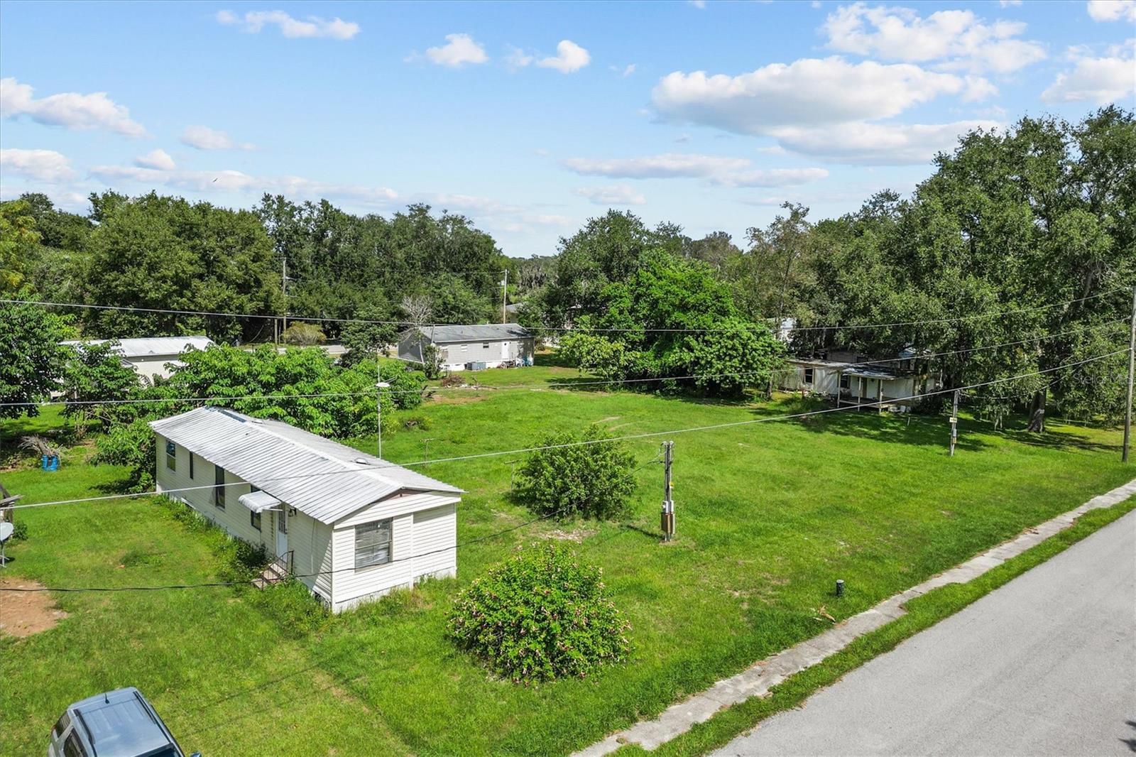 Attention investors, builders, and handy homeowners! This is a unique opportunity to own a 2-bedroom, 1-bath mobile home on nearly half an acre in Polk City, FL, accompanied by two additional vacant lots — both already equipped with electric and septic.
The mobile home needs work, making it a perfect fixer-upper or rental rehab project. Live in it while you renovate, or replace it entirely and unlock the potential of three separately usable parcels.
With no HOA and plenty of flexibility, the additional lots could support new mobile homes, RVs, or income-producing structures (buyer to verify)