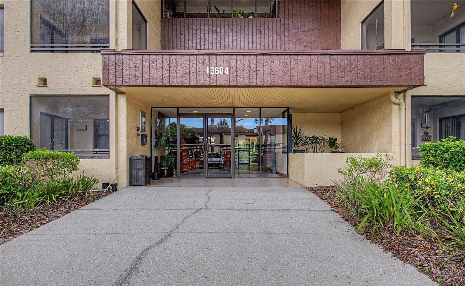 CARROLLWOOD VILLAGE – EXCEPTIONAL LIVING in an UNBEATABLE LOCATION! ~ This beautifully RENOVATED FIRST-FLOOR condo puts you in the heart of one of Tampa’s most desirable communities! Light, bright, and move-in ready, this spacious condo features an open floor plan with the UPDATED KITCHEN flowing seamlessly into the dining and living areas—perfect for both everyday living and entertaining. ~ The roomy kitchen offers abundant granite countertop space, a beautiful backsplash, and stainless steel appliances (all INCLUDED). The desirable SPLIT-BEDROOM LAYOUT provides privacy, while laminate flooring throughout the living areas and bedrooms and tile flooring in the kitchen and bathrooms create a stylish, low-maintenance living space. ~ The primary suite is a true retreat, featuring sliding glass doors leading to a private screened patio, an updated ensuite bath with a beautiful vanity, and a tiled walk-in shower. The second bedroom and living room share access to a second screened patio, providing additional outdoor living space to relax and enjoy Florida’s beautiful weather. Additional highlights include a newer A/C (2024), a spacious laundry area with newer FULL-SIZE WASHER & DRYER INCLUDED, and a designated covered parking space! ~ Village Towers residents enjoy outstanding amenities and services - including a large screened pool surrounded by generous sunbathing areas and a spacious screened pavilion with plenty of comfortable shaded seating, and a tennis court that is also striped for pickleball. Services include basic cable, high-speed internet, water, sewer, trash, grounds maintenance, building maintenance, and much more! ~ As a resident of Carrollwood Village, you'll ENJOY access to an INCREDIBLE LIFESTYLE just minutes from your front door. Nearby CARROLLWOOD VILLAGE PARK features a splash pad, dog parks, playgrounds, skate park, outdoor fitness equipment, challenge course, walking trails, fishing pier, soccer fields, pickleball and tennis courts, arboretum, nature center, picnic shelters, scenic ponds, and countless recreational opportunities. You'll also appreciate the convenience of the Carrollwood Cultural Center, Carrollwood Country Club, Publix, Target, specialty shops, popular restaurants, medical centers, and hospitals—all just minutes away. ~ Conveniently located near Dale Mabry Highway with easy access to the Veterans Expressway, I-275, and Tampa International Airport, this exceptional condo offers the perfect combination of comfort, amenities, convenience, and the sought-after Carrollwood Village lifestyle. Don't miss this opportunity to enjoy maintenance-free living in one of Tampa's most established and vibrant communities!!