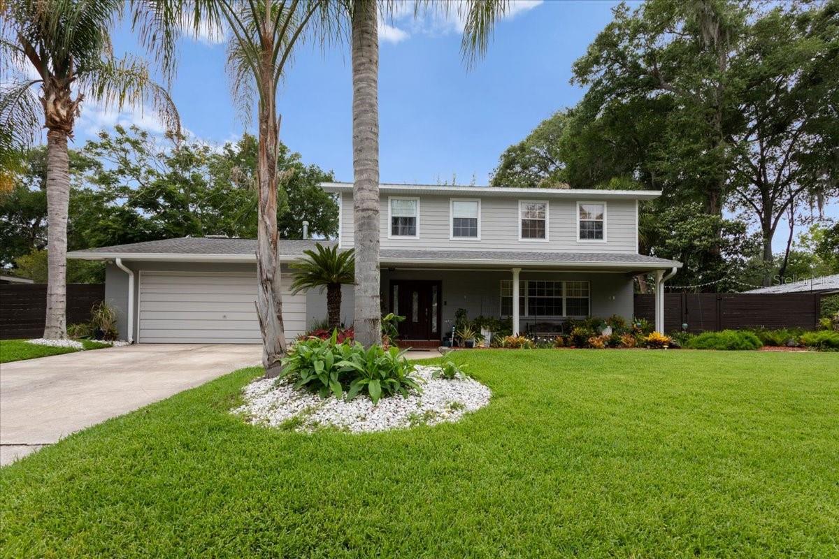 Nestled in the highly desirable Greenbriar neighborhood off NW 34th Street, this beautifully maintained 4-bedroom home offers the perfect combination of convenience, privacy, and resort-style living. Located just minutes from UF, Shands, North Florida Regional Medical Center, shopping, dining, and Gainesville’s major thoroughfares, this quiet and peaceful property feels like a private retreat tucked away from the hustle and bustle. From the moment you arrive, you’ll be captivated by the mature palm trees, lush landscaping, expansive front lawn, and welcoming covered front porch. Inside, the brilliant floor plan is designed for both comfortable everyday living and effortless entertaining. 
The home features four bedrooms, two full and one-half bathroom with multiple flexible living spaces, and abundant natural light throughout. The updated kitchen is the heart of the home, offering white cabinetry, stainless steel appliances, stone countertops, a breakfast bar, and an adjoining dining area perfect for family meals and holiday gatherings.

One of the home’s most unique features is the abundance of indoor living space. Enjoy three separate entertainment and gathering areas, including a large family room overlooking the backyard oasis, a formal living room, and an additional flex space ideal for a media room, game room, home office, library, or fitness area. A cozy fireplace with custom built-ins creates the perfect setting for relaxing evenings at home.

Upstairs, the primary suite provides a peaceful retreat, while three additional bedrooms offer flexibility for family, guests, hobbies, or work-from-home needs.

Step outside and discover your own private tropical paradise. The backyard has been thoughtfully designed for year-round Florida living and entertaining, featuring a sparkling resort-style swimming pool surrounded by mature tropical landscaping and privacy fencing. Relax beside the tranquil koi pond complete with lily pads, decorative fountains, and soothing water features, or gather with friends under the covered tiki-style outdoor kitchen and entertainment pavilion featuring a sink, refrigerator, prep space, ceiling fan, and grilling area.

Additional outdoor amenities include expansive paver patios, a fire pit area, multiple seating and relaxation spaces, and a gated side-entry parking area perfect for a boat, trailer, golf cart, recreational vehicles, or additional storage.**All major systems updated including electrical, plumbing (tankless water heater) and roof.***

Whether you’re hosting poolside gatherings, enjoying peaceful mornings beside the water garden, relaxing around the fire pit, or simply appreciating the quiet surroundings, this exceptional Greenbriar property offers a lifestyle that feels like a permanent vacation.

Schedule your private showing today and experience one of Greenbriar’s most unique and inviting homes. NO HOA.