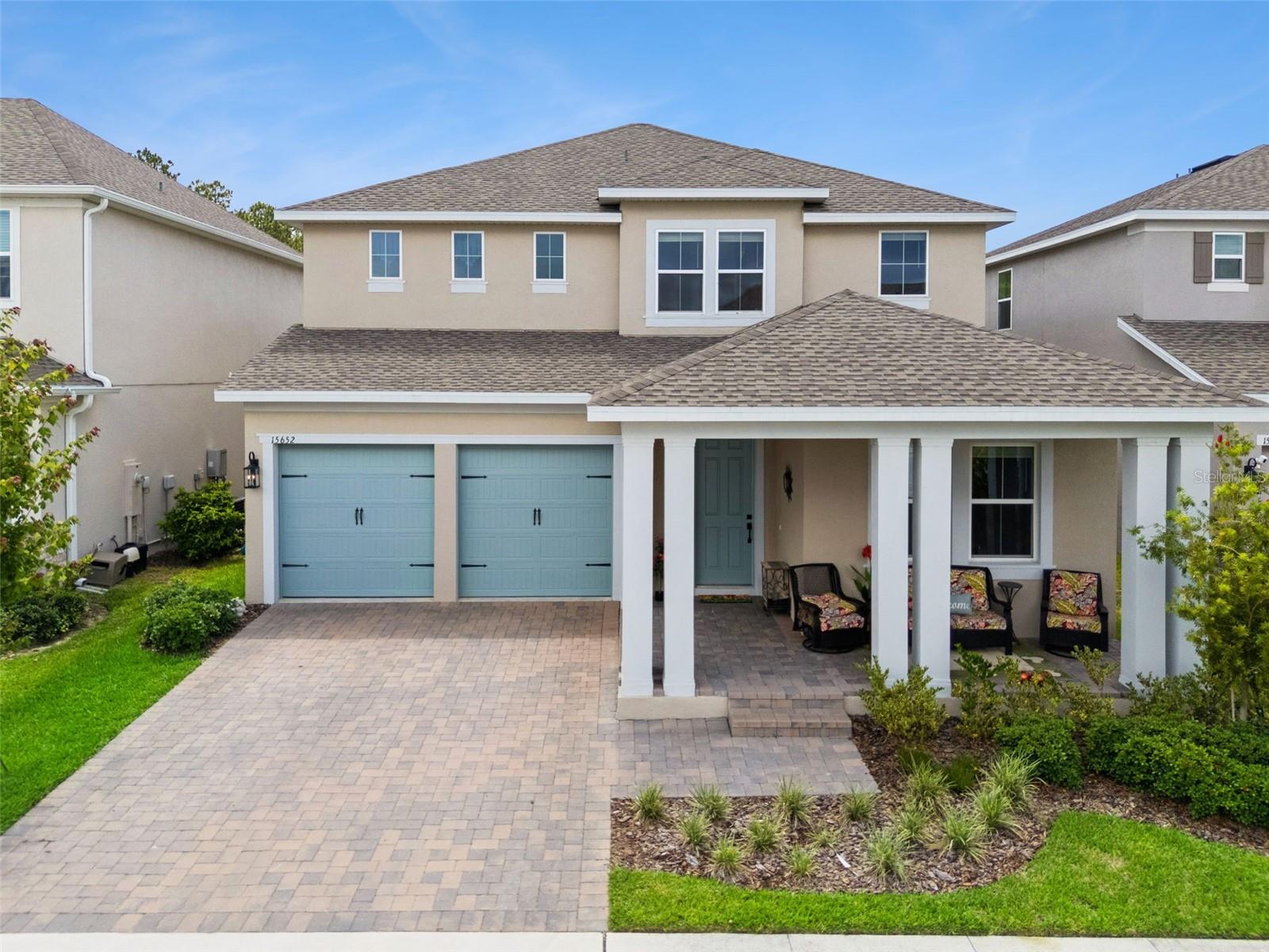 One or more photo(s) has been virtually staged. Welcome to one of the most beautifully designed homes in the highly sought-after Ovation of Horizon West. A master planned community where luxury, lifestyle, and location come together. Built less than 2 years ago, this exceptional 5-bedroom, 4.5-bath residence offers over 3,600 square feet of thoughtfully designed living space, stunning modern farmhouse finishes throughout, and a  premium location! From the moment you step inside, the home delivers an unforgettable WOW factor. Anchored by an oversized island and designer gourmet kitchen with natural gas efficiently for any chef’s delight. 
Includes premium cabinetry, quartz countertops, and premium fixtures. This open-concept floorplan was made for entertaining and everyday living alike.
 The expansive great room flows seamlessly to the covered lanai and spacious backyard, perfectly positioned to capture breathtaking sunset views over open farmland and has plenty of room to build your dream pool and no rear neighbors! The stellar floorplan features three ensuite bedrooms, including a luxurious primary suite plus two secondary ensuite spaces, one conveniently located downstairs, making it ideal for guests or multigenerational living. This home also provides loads of storage space, which is a rare find. One of the most magical features of this home? Disney fireworks views from the front porch, den, and upstairs bedroom, giving you front-row seating to the nightly magic. Community amenities include: Pool, Splash Pad, Playground, Hiking & Biking Trails. Perfectly situated in the heart of Horizon West, this home is 4 minutes to Disney property, walking distance to Flamingo Crossings shopping and dining, and brand-new Ovation Elementary School opening August 2026. Convenient access to Hamlin, downtown Winter Garden, MCO, major roadways, shopping, dining, and entertainment make this location truly hard to beat. A rare combination of design, quality, functionality, views, and proximity to Disney. This is Central Florida luxury living at its best!