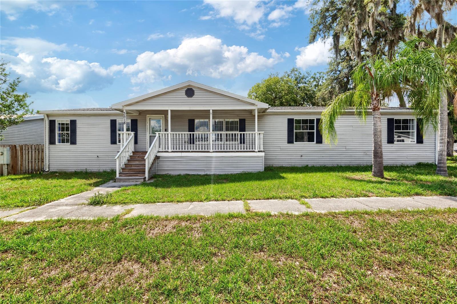 Short Sale. Investor special in the heart of Wesley Chapel with no age restriction and major upside potential! This spacious 2001-built doublewide home offers 5 bedrooms, 3 full bathrooms, and over 2,200 square feet of living space on a large corner lot in a convenient location near shopping, dining, schools, and major roadways. Featuring a desirable split floorplan, oversized living areas, and a high bedroom count, this property presents an excellent opportunity for investors, buy-and-hold portfolios, PadSplit-style housing, or large multi-generational living arrangements. Major updates completed in 2021 include granite countertops, all-wood cabinetry with soft-close drawers, stainless steel appliances, recessed lighting, updated bathrooms, dimensional shingle roof, and 5-ton HVAC system. The oversized primary suite features a private en-suite bath with a beautiful standalone soaker tub, separate shower, and ample storage space. Water heater replaced in 2023. Exterior features include covered front and rear porches, a fully fenced backyard, and oversized parking area. LOW HOA and NO CDD. Property requires repairs and is priced accordingly.  Home will not qualify for regular FHA loan in current condition but may qualify for FHA 203(k) loan. Bring your vision and unlock the potential of this income-producing opportunity in one of Pasco County’s fastest-growing areas.