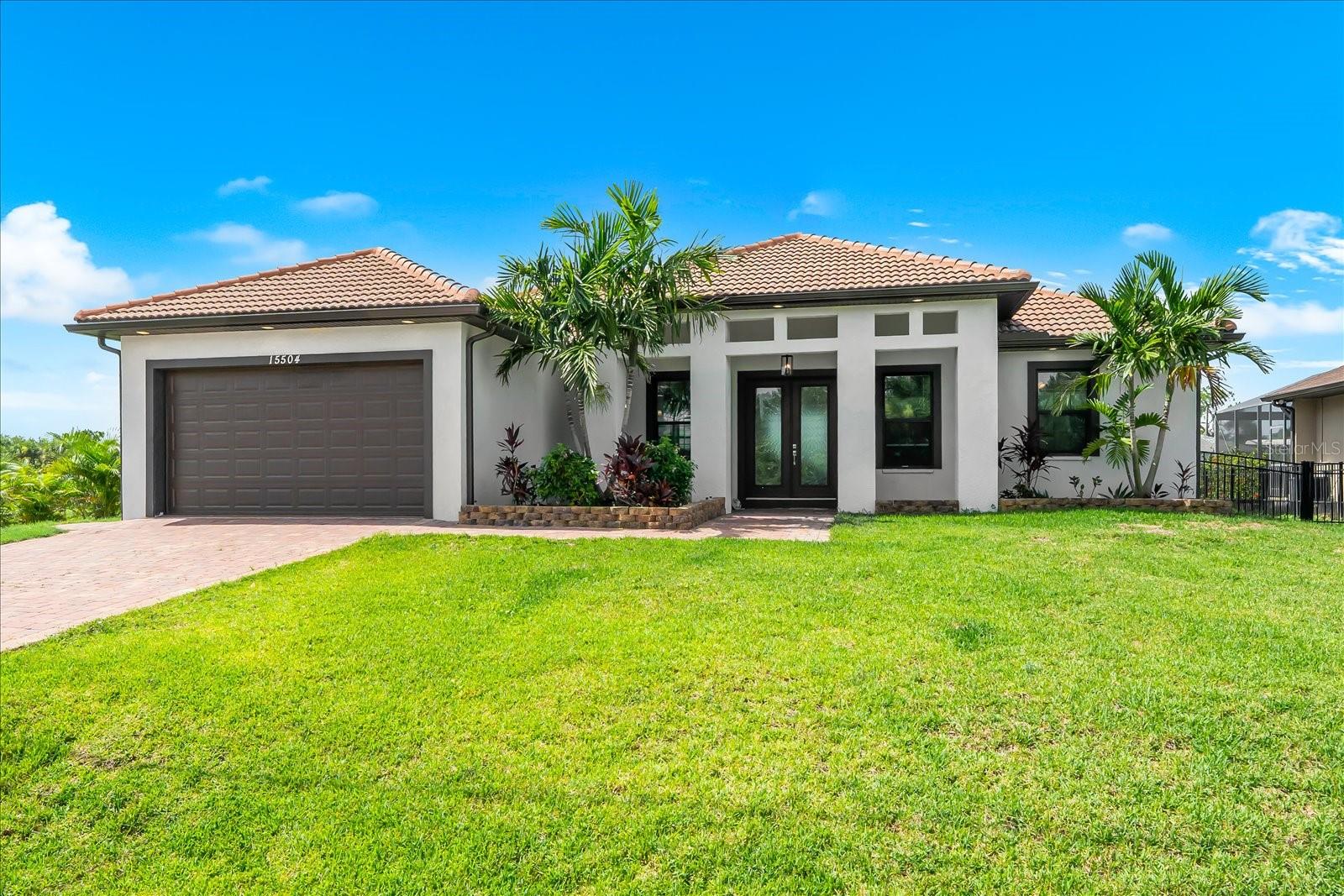 Welcome to your PRIVATE WATERFRONT PARADISE in the highly sought-after community of SOUTH GULF COVE! This SPECTACULAR CUSTOM-BUILT, SOUTH-FACING COASTAL LUXURY RESIDENCE offers 2,105 square feet of thoughtfully designed living space, 3 bedrooms, 2 bathrooms, 80 feet of canal frontage with DIRECT GULF ACCESS—delivering the ULTIMATE FLORIDA LIFESTYLE with NO HOA REQUIREMENT and NO CDD FEES!! This exceptional home immediately captivates with INCREDIBLE CURB APPEAL!! Featuring a coveted TILE ROOF, elegant paver driveway, recessed exterior lighting, and a grand double French door entry, every detail creates an unforgettable first impression. Step inside to soaring tray ceilings with custom lighting, extensive crown molding, stylish wood-grain ceramic tile flooring throughout, and a bright, open floor plan that draws your eye through the dramatic sliding glass doors to the SPARKLING HEATED POOL and breathtaking waterfront beyond!! Designed for everyday living and effortless entertaining, the gourmet kitchen is truly the heart of the home! It showcases stunning granite countertops that continue as a full-height backsplash, a spacious breakfast bar, abundant soft-close cabinetry, updated Samsung smart stainless-steel appliances, and a sunny dinette overlooking the lanai. A spacious indoor laundry room with an upgraded utility sink adds even more convenience. Escape to the LUXURIOUS PRIMARY SUITE, a private retreat featuring elegant tray ceilings with built-in lighting, a generous walk-in closet, and a spa-inspired ensuite with dual vanities topped with matching granite countertops, an oversized garden tub, and a custom tiled walk-in shower with built-in shelving. Two additional guest bedrooms are generously sized with built-in closets, while the beautifully appointed guest bath features a stylish walk-in shower. The outdoor living space is where this home truly SHINES!! Expansive 8 ft sliders create a seamless transition to the oversized covered and screened lanai, where you'll discover your own PRIVATE BACKYARD OASIS!! Relax in the custom HEATED GUNITE POOL featuring an inviting sun shelf with umbrella sleeve, surrounded by elegant paver decking —perfect for entertaining family and friends or simply enjoying the peaceful canal views. This desirable SOUTH-FACING EXPOSURE provides abundant Florida sunshine all day long!! Boating enthusiasts will LOVE the ample room to customize your own private lift/dock, with outstanding fishing right from your backyard and DIRECT ACCESS TO CHARLOTTE HARBOR AND THE GULF!! Built with comfort, efficiency, and peace of mind, this exceptional residence features hurricane-rated LOW-E IMPACT WINDOWS AND DOORS, open-cell spray foam attic insulation, smart home technology, and an oversized two-car garage with an easy-to-maintain epoxy floor. Perfectly situated near pristine Gulf beaches, HISTORIC BOCA GRANDE, Warm Mineral Springs, championship golf courses, premier shopping and dining, a nearby water park, and countless outdoor recreation opportunities, this remarkable waterfront residence offers LUXURY, LOCATION, AND LIFESTYLE in one extraordinary package!! THIS IS MORE THAN JUST A HOME—IT'S YOUR FLORIDA DREAM COME TRUE!! Don't miss this RARE OPPORTUNITY to own a DIRECT GULF ACCESS waterfront pool home in one of Southwest Florida's most desirable boating communities. SCHEDULE YOUR PRIVATE SHOWING TODAY BEFORE THIS INCREDIBLE HOME IS GONE!!