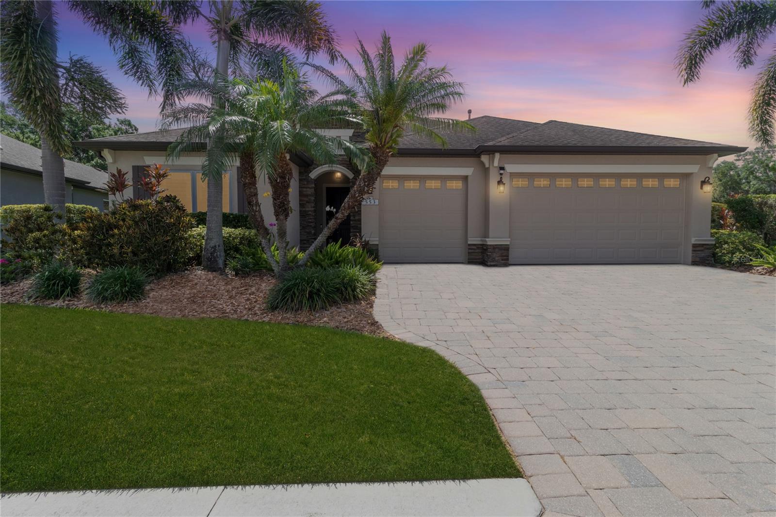 Welcome to Greyhawk Landing, one of East Manatee County's most sought-after gated communities, where resort-style amenities, natural beauty, and an active lifestyle come together. Situated on a private preserve lot, this impressive 4-bedroom, 3-bath 2015 built Kingsley model is one of the community's most desirable floor plans, offering generous living spaces, thoughtful design, luxury finishes, and exceptional energy efficiency. 


Step inside and be captivated by the soaring vaulted ceilings and expansive open-concept design. The spacious great room flows seamlessly into the heart of the home—a stunning gourmet kitchen featuring a gas cooktop, built-in oven, microwave/convection oven, breakfast bar, dinette area, and a dramatic custom exhaust hood that extends all the way to the peak of the vaulted ceiling, creating a truly unforgettable focal point. For more formal occasions, enjoy a separate dining room perfect for entertaining family and friends.

The thoughtfully designed Kingsley floor plan offers flexibility and privacy. The luxurious primary suite features coffered ceilings, two WALK-IN CLOSETS, sliding glass doors to the screened lanai, and a spa-inspired ensuite bath with split vanities, a large walk-in shower, and private water closet. Bedrooms two and three are generously sized and share a full bath, while the fourth bedroom and third bath are tucked behind a pocket door and feature a separate exterior entrance—ideal for guests, MULTI-GENERATIONAL LIVING, a home office, or private retreat.

Additional features include tile flooring throughout, an indoor laundry room with utility sink, a mudroom with built-in desk, and an oversized three-car garage providing abundant storage space.

Enjoy peace of mind with numerous protective features including in-wall pest control, HURRICANE SHUTTERS for the sliding glass doors, and the revolutionary Crimsafe HURRICANE IMPACT SCREENS on all windows.

This home is also equipped with SOLAR PANELS and a TESLA HOME BATTERY BACKUP SYSTEM, dramatically reducing energy costs while providing power security during storms and outages. Best of all, the SOLAR SYSTEM WILL BE PAID IN FULL AT CLOSING—providing immediate savings for the new owner with no additional expense.

The fenced backyard overlooks a peaceful preserve, creating a private setting perfect for pets, outdoor enjoyment, and watching Florida's natural wildlife.

One of the greatest advantages of this home is that you can enjoy all the benefits of Greyhawk Landing's exceptional amenities without the responsibility of maintaining a private pool. The community pool is conveniently located just around the corner, allowing residents to enjoy swimming and recreation without the added expense, maintenance, insurance concerns, or safety worries often associated with private pools.

Should you decide on a pool for yourself, there is plenty of room and the home has already been readied for either a pool, an outdoor kitchen, or both!

Greyhawk Landing offers an unmatched lifestyle with multiple community pools, pickleball courts, tennis courts, basketball courts, playgrounds, scenic lakes, fitness opportunities, and miles of picturesque nature trails winding through beautifully preserved landscapes.

This exceptional home combines luxury, practicality, energy efficiency, and resort-style living in one of the area's most desirable communities. Don't miss this rare opportunity to enjoy the very best of Greyhawk Landing.