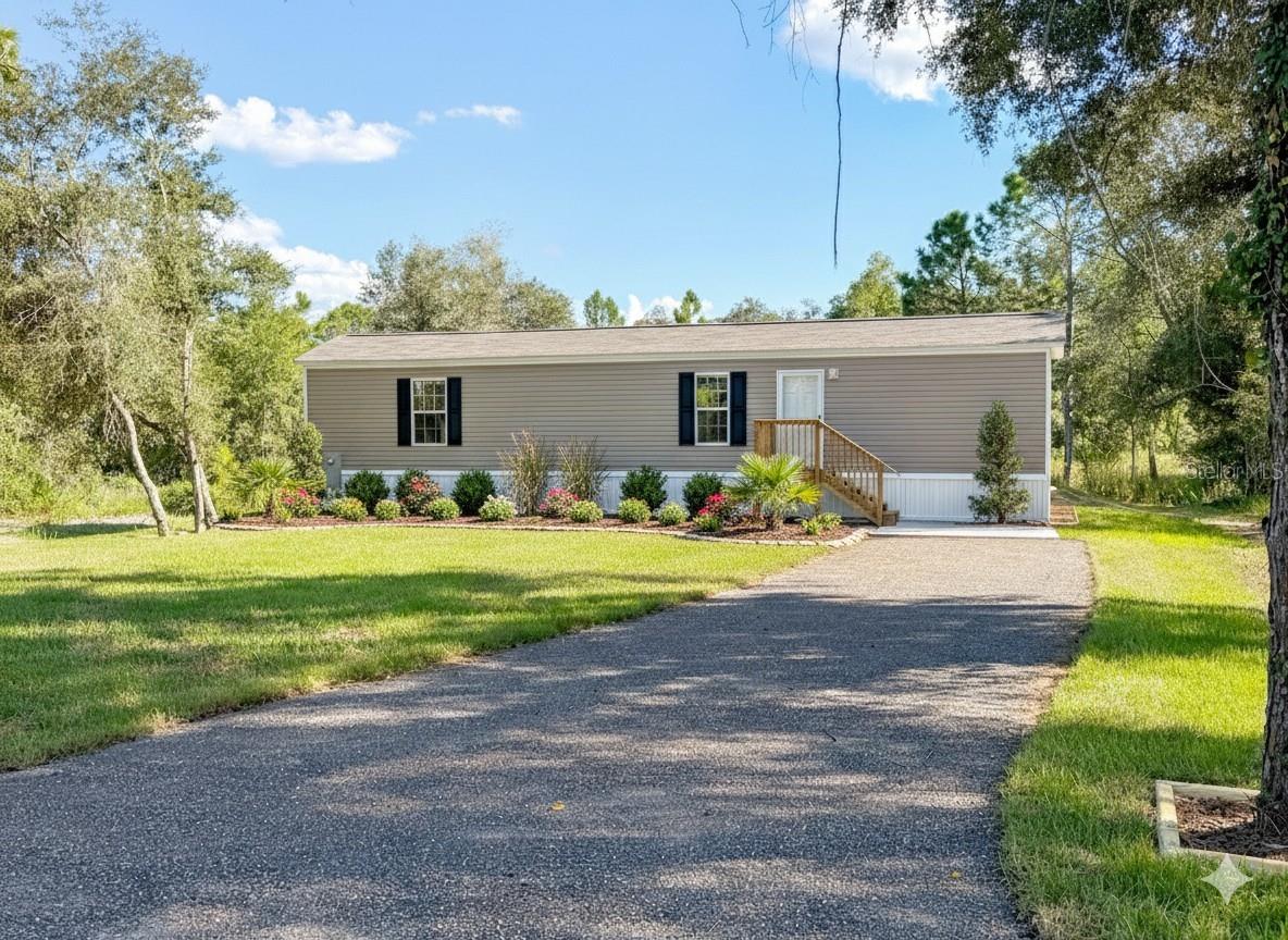 One or more photo(s) has been virtually staged. Experience Peaceful Country Living with Modern Comforts! Welcome to 9448 Rousseau Street, a beautifully designed 2-bedroom, 2-bath manufactured home that perfectly blends modern convenience with the tranquility of Florida’s countryside. Built in 2025, this move-in-ready property sits on a spacious 0.24-acre lot in the quiet, rural community of Webster — offering the privacy you crave without sacrificing accessibility.

Step inside to discover a bright and open floor plan with luxury laminate flooring, a spacious living area, and a modern kitchen featuring sleek cabinetry and quality finishes. The split-bedroom layout ensures privacy, making it ideal for families, guests, or anyone looking for a functional and comfortable space. Enjoy the convenience of a dedicated laundry room, energy-efficient construction, and a raised foundation with a paved driveway for added peace of mind.

Outside, you’ll love the wide-open surroundings, perfect for relaxing evenings, weekend barbecues, or simply enjoying the calm of nature. Whether you’re downsizing, buying your first home, or looking for a peaceful getaway from the city, this property offers the best of both worlds — serenity and convenience.

Located just a short drive from local shops, dining, and parks, and within easy reach of major routes to nearby towns, you’ll enjoy both privacy and accessibility.