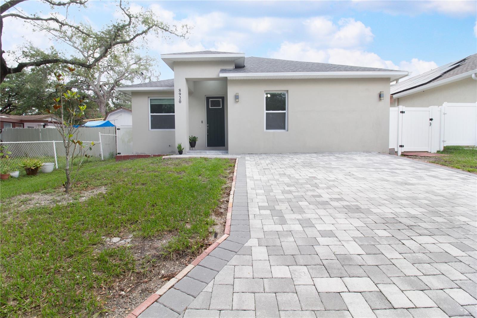 Your Dream Home Awaits: Modern Living, Double Income, and Very Low Electric Bills in Tampa! Welcome to one of Tampa's most unique opportunities — a stunning modern home that doesn't just offer a place to live, but a lifestyle that works for you. Nestled in a peaceful neighborhood near Lowry Park Zoo and the Hillsborough River, this beautifully designed 4-bedroom, 3-bathroom property sits in one of the city's most coveted pockets — just 10 minutes from Downtown and moments from top destinations like Busch Gardens, Armature Works, USF, restaurants, shops, and parks. Step inside and feel the difference immediately. Soaring vaulted ceilings flood the home with light and openness, setting the tone for the thoughtful design throughout. The heart of the home is a chef-inspired Kitchen and Family Room combo, featuring a stylish island, elegant quartz countertops, and shaker cabinets — perfect for entertaining or unwinding after a long day. Natural light pours through every corner, creating a warm and inviting atmosphere that's hard to put into words until you're standing in it. Retreat to your luxurious master suite, complete with a spacious walk-in closet and a spa-like bathroom boasting a double vanity and walk-in shower. Two additional bedrooms and a full bathroom round out the main living space, offering comfort and flexibility for families of any size. Step outside to your private rear patio — your own slice of Tampa sunshine. Now here's where it gets even better. This property features a fully (permitted) independent mother-in-law suite — a charming, self-contained apartment that opens the door to endless possibilities. Whether you're housing a loved one who values their independence, hosting long-term guests, or generating monthly rental income, this second unit is a gamechanger. And as if that weren't enough — say goodbye to high electric bills. This home comes equipped with a fully paid-off solar panel system, courtesy of the seller, meaning you inherit all the savings and none of the debt. Clean energy. The bottom line This is a smart investment, a flexible living solution, and a modern sanctuary — all wrapped into one address. Opportunities like this don't wait. Schedule your private showing today. Can you condense it? Make it smaller, inconsistent.