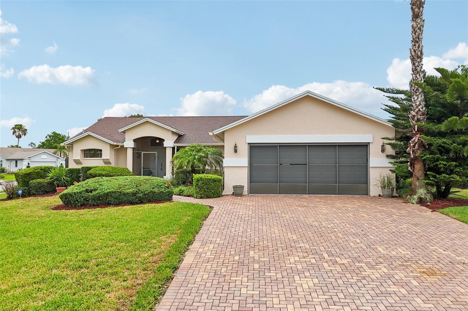Move right into this well maintained 3 bedroom, 2 bathroom home offering approximately 1768 square feet of living space in the desirable Estates of Beacon Woods. Situated on a corner lot, this home offers added curb appeal with a paver driveway, mature landscaping, and gutters already in place. The thoughtfully designed floor plan provides multiple living spaces, abundant natural light, and a layout that makes everyday living easy.

The updated kitchen features granite countertops, stainless steel appliances, and plenty of workspace, along with a convenient breakfast nook that overlooks the backyard. Just off the kitchen is a dedicated office area, creating an ideal space for working from home, managing household tasks, or pursuing hobbies.

The spacious living and dining areas are filled with natural light from large windows and sliding glass doors that open to the impressive screened lanai. Measuring over 34 feet long, this outdoor living space provides plenty of room for dining, relaxing, and enjoying Florida's year round weather. The lanai is accessible from both the living room and the primary bedroom, creating a seamless connection between the indoor and outdoor living spaces.

The primary suite offers a large walk in closet and an ensuite bathroom, while the split bedroom layout provides privacy for guests or family members. A second bedroom and full bathroom are positioned on the opposite side of the home, and the additional media room offers flexible living space for a second sitting area, game room, or TV room. Carpet runs throughout the living areas and bedrooms, adding warmth and comfort.

Additional highlights include an interior laundry room, a spacious 2 car garage with sliding screen doors, a screened front entry, paver driveway, corner lot location, and gutters for added convenience.

Located in The Estates of Beacon Woods, residents enjoy access to outstanding community amenities including a clubhouse, swimming pool, fitness center, tennis courts, and beautifully maintained common areas. The community is conveniently located near shopping, restaurants, medical facilities, parks, golf courses, and the Gulf Coast, offering easy access to everything the Hudson area has to offer.