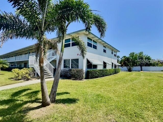 Charming ... Maintained with Love ... ! Popular extra-large 2-Bedroom 2-Bath Corner Condo ...  in Paradise Shores. You won't believe your eyes. From the moment you open the front door.... you know you are Home...! Popular open floor plan with loads of room for entertaining. Inviting living area and dining area loads of updated windows and easy maintenance tile flooring thru-out. The galley style kitchen offers abundance of cabinets, counter space and a large pantry....Just perfect for any Chef. The Florida-room is cozy and comfortable, offers abundance of windows for natural light and large storage closet for all of your treasures. The Spacious Master Bedroom includes a wall of double closets and a private en-suite bath that offers an oversized shower. The large Guest bedroom or 2nd Bedroom is privately located down the hall and offers a large closet and updated windows for natural light and is perfect for all of your guests. Be careful .... your guests may not want to leave. The split bedroom floorplan is separated by the main bath floorplan provides plenty of privacy for overnight visitors. The main bath is updated with a oversized walk in shower complete with designer like tile. An additional storage and a covered carport completes your new Home. The low monthly HOA fee includes Internet, Wifi, Cable TV, Gas for Cooking and Heat and Hot Water, building exterior, reserves, building insurance, grounds maintenance, recreational facilities, roof, trash, sewer and water. Paradise Shores is a Resort Style Community known for it's many amenities and superb location. The RESORT STYLE COMMUNITY, is Centrally located near the Beaches and I-275. This 55+ Active Community features a recreation center with a library, community room for activities, a full kitchen for parties, a heated swimming pool, large shuffle board area, a bocce court, a firepit and a wonderful barbecue and picnic area. Sorry, unfortunately pets are not permitted. Minutes to local Beaches, additional shopping and the Tyrone Mall, Downtown St. Petersburg and the new Pier. And don't forget, its an easy commute to Tampa International Airport. Whether this is your fulltime Home or your second vacation Home.... this special Condo is Home! Welcome HOME...! Call today for your personal tour or FaceTime RealTime Tour.