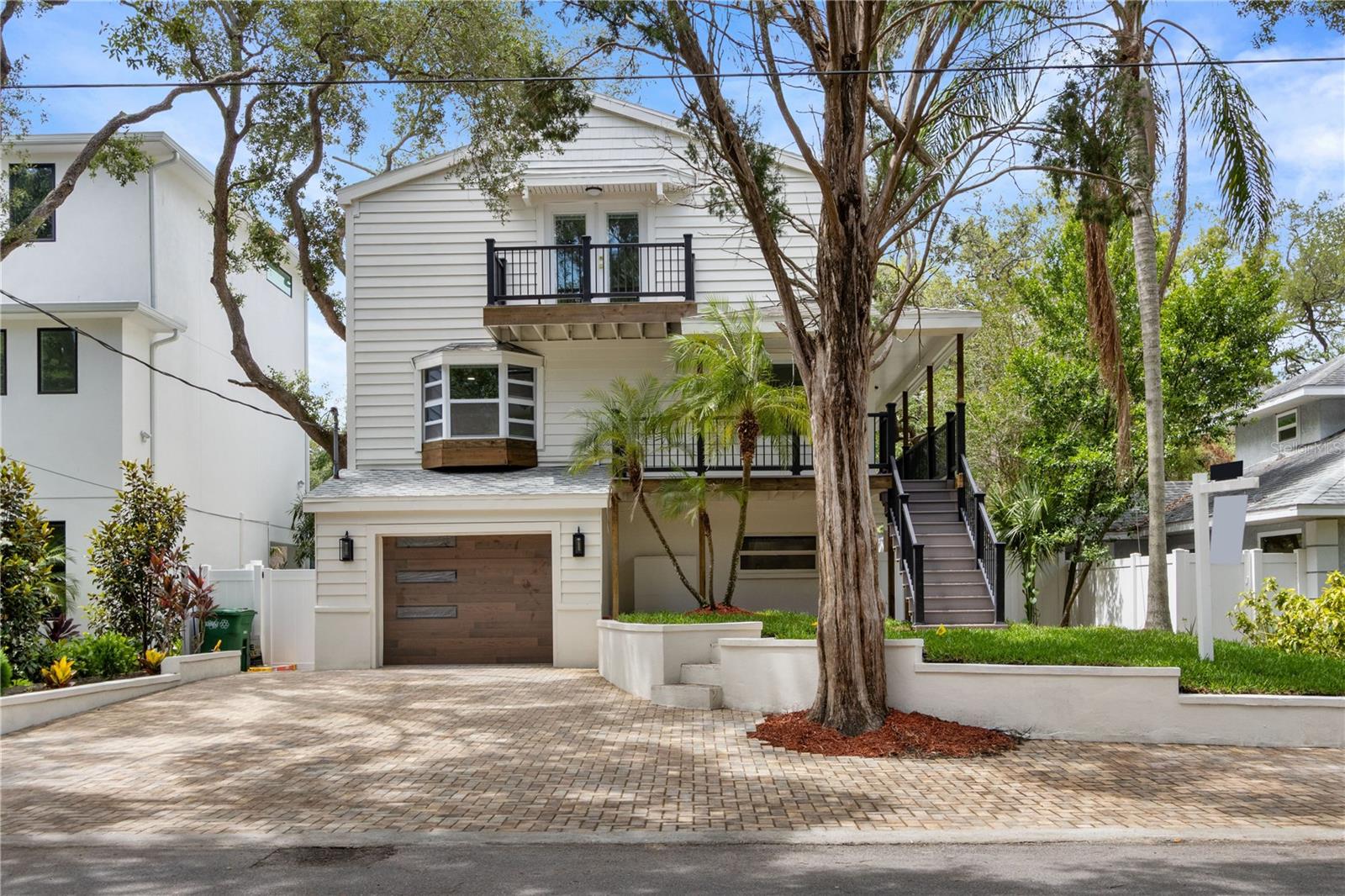 Welcome to 3232 W Oakellar Ave — a stunning top-to-bottom renovation in the heart of South Tampa’s  Bayshore Beautiful neighborhood. This 4-bedroom, 3.5-bathroom home offers 2,202 square feet of thoughtfully designed living space with high-end finishes throughout. The standout feature of this home is the private first-floor living suite — complete with its own kitchenette, full bathroom, bedroom, and private laundry area. Ideal for multi-generational families, in-laws, extended guests, or added privacy, this space functions as a self-contained living setup while remaining connected to the main residence. The main kitchen on the second floor is a showstopper — featuring Taj Mahal quartzite countertops, custom cabinetry with gold hardware, a designer marble backsplash, custom range hood, gold pot filler, and all-new stainless steel appliances. The third floor hosts three bedrooms including a luxurious master suite with walk-in closet and private balcony access, plus a dedicated laundry area. Additional upgrades include all-new plumbing, completely updated electrical, two brand-new AC units, new water heater, new windows, new luxury flooring throughout, and a newly built composite deck. The paver driveway, lush landscaping, dual balconies, and mature oak-lined street complete this exceptional property. Located minutes from Bayshore Boulevard, Hyde Park, Downtown Tampa, waterfront parks, top-rated restaurants, and major roadways. This is a rare opportunity to own a fully turnkey home in one of Tampa’s most sought-after neighborhoods.