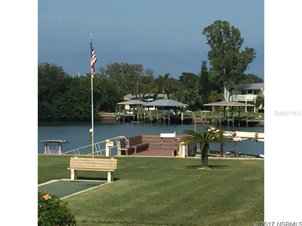 What a great condo located between the downtown Canal Street Historical District and Flagler Avenue.  This Ground Floor corner unit  2 bedroom 2 bath is well kept with newer kitchen, tile floors, screened patio overlooking the pool, putting green, and shuffle board courts.  Walk a few more feet and enjoy fishing off the community dock!  This unit has it's own washer and dryer, parking within feet of the front door, electric hurricane shutters on sliders.  Condo fees cover cable, hot water, water, and trash.  The building is poured concert built to last. This wonderfully appointed common area's make this unit feel like you are on permanent vacation! ;LocationDescription: Condo ;Water: City