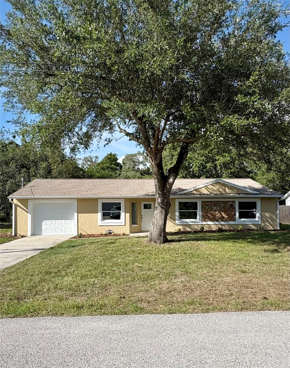 Don't miss this beautifully remodeled, move-in-ready home. Located in a quiet neighborhood with convenient access to US-19 and the Suncoast Parkway. Extensively updated from top to bottom, this home features a new roof and gutters. Newer A/C system and duct-work. New windows and doors throughout. New garage door and automatic opener, electrical panel along with outlets, switches and light fixtures. Inside, you'll find elegant porcelain plank tile flooring throughout the entire home. Both bathrooms have been completely remodeled with new tile, vanities and high-efficiency toilets. The stunning new kitchen showcases soft-close cabinets and drawers, quartz counter-tops, a stone back-splash and brand-new stainless steel appliances. Fresh interior and exterior paint add to the home's modern appeal. Outside, newly installed sod enhances both the front and back yard, while a new irrigation system with timer helps keep the lawn looking its best year-round. Enjoy the freedom of no HOA or CDD fees and no deed restrictions. Conveniently located near shopping, restaurants, medical facilities and outdoor recreation, this home is less than 10 minutes from Weeki Wachee Springs State Park and just 15 minutes from Pine Island Beach Park. You'll also be approximately 40 minutes from Tampa and about an hour from Clearwater Beach. This beautifully upgraded home offers the feel of new construction without the wait. Schedule your showing today!