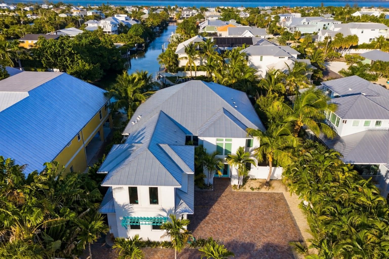 An exceptional opportunity to experience true island living where waterfront boating and beach access come together—just minutes apart—on Anna Maria Island.

This beautifully designed 4-bedroom, 4.5-bath turnkey furnished coastal residence offers a rare blend of luxury, comfort, and lifestyle, ideally situated on a tranquil canal while remaining only moments from the island’s world-famous white-sand beaches.



Homes offering private boating access this close to the beach are increasingly difficult to find on Anna Maria Island. From this property, enjoy the freedom of launching your boat from your own backyard, paddleboarding at sunrise, or cruising to open water—then return home and head to the beach cart in minutes. It is this seamless balance of water, sand, and island convenience that truly sets this home apart.



Built in 2020 and thoughtfully designed for modern coastal living, the home features a bright, open floor plan filled with natural light and enhanced by coastal-inspired finishes and refined details throughout. The gourmet kitchen serves as the heart of the home, equipped with top-of-the-line stainless steel appliances, quartz countertops, a wine refrigerator, and generous prep and storage space—perfect for entertaining after a day on the water or hosting family and friends.



Each of the four bedrooms includes a private en-suite bath, offering comfort and privacy for owners and guests alike. An elevator provides easy access to all levels, adding convenience for everyday living.



Outdoor living is where this home truly shines. The private backyard retreat features a heated pool and spa with sun exposure, an expansive pool deck, lush tropical landscaping, and multiple outdoor living and dining areas designed for relaxing, entertaining, and enjoying the island breeze. Whether you’re gathering for sunset cocktails, enjoying a quiet evening under the stars, or unwinding after a beach day, this space feels like a personal resort.



For boating enthusiasts, the property offers a private 16’ dock and an oversized boat slip measuring approximately 12’ x 35’, providing direct access to Tampa Bay and the Gulf. This setup is ideal for daily cruising, fishing excursions, paddleboarding, or simply enjoying the peaceful waterfront setting.



Situated on an unusually large lot for Anna Maria Island with over 12,000 sq ft , the home also provides ample parking, a spacious driveway, garage, and dedicated golf cart storage—features that add meaningful convenience for both owners and guests in this sought-after location.



Located in the heart of Anna Maria Island, this property places you just minutes from pristine beaches, Pine Avenue’s charming boutiques and dining, Bean Point’s legendary sunsets, local art galleries, and the island’s laid-back, walkable, golf-cart-friendly lifestyle. Known for its relaxed pace, vibrant community, and old-Florida charm, Anna Maria Island continues to be one of Florida’s most beloved coastal destinations.



Whether you are searching for a full-time residence, a luxury second home, or a proven income-producing vacation rental with forward bookings already in place, this exceptional property offers unmatched versatility and long-term value. Combining waterfront access, beach proximity, turnkey luxury, and an unbeatable island location, this home represents a rare chance to own one of Anna Maria Island’s most desirable lifestyle properties.