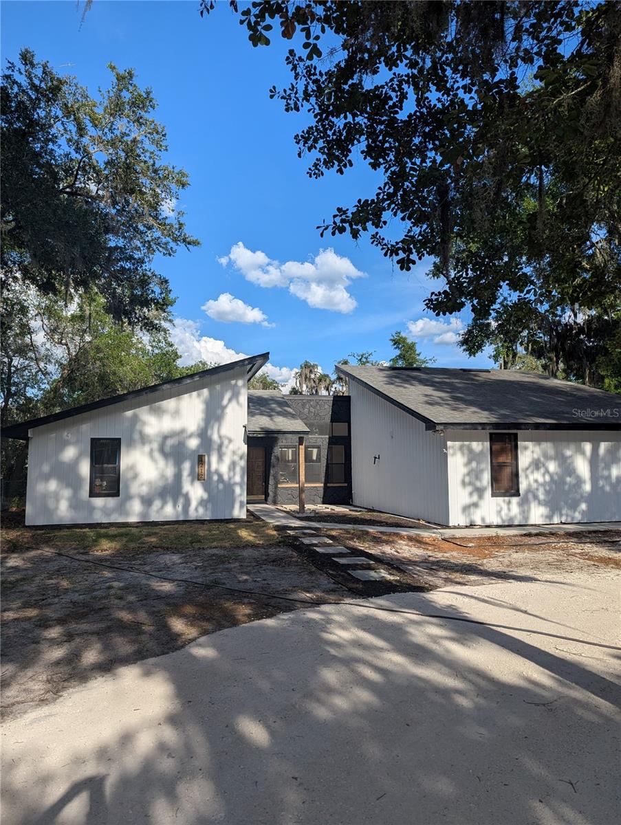 Coming Soon!... This Unique Opportunity in South Lakeland: Your Dream Home Awaits! Don't miss your chance to own a truly unique property in a charming, close-knit South Lakeland neighborhood. Nestled on just under an acre of land, this home has been thoughtfully remodeled and is ready to be your perfect family retreat. It's a one-of-a-kind residence that stands out from all the rest. The heart of the home is a central atrium, a true showstopper which provides cascading sunlight to the entry, dining, kitchen and living areas through expansive floor to ceiling windows. This architectural feature creates a striking connection to the outdoors. The cedar trim adds rustic character and warmth. Solid stone surface countertops in the kitchen with new cabinetry and appliances await you with additional storage space in the butler pantry also accommodating a sink and wine fridge.  The primary suite and family room are both generously sized, featuring large sliding glass doors that open to the back screened lanai, perfect for enjoying a quiet morning coffee or hosting gatherings. Outside, the property is a dream for those with hobbies and "toys." A separate, fenced-in area with direct access to Hatcher Road is perfect for parking a boat or RV. And with no HOA, you have the freedom to bring whatever you want! This is more than a home—it's a lifestyle. It’s for the family looking to create lasting memories in a house that truly reflects their style. This is one to get your hands on.