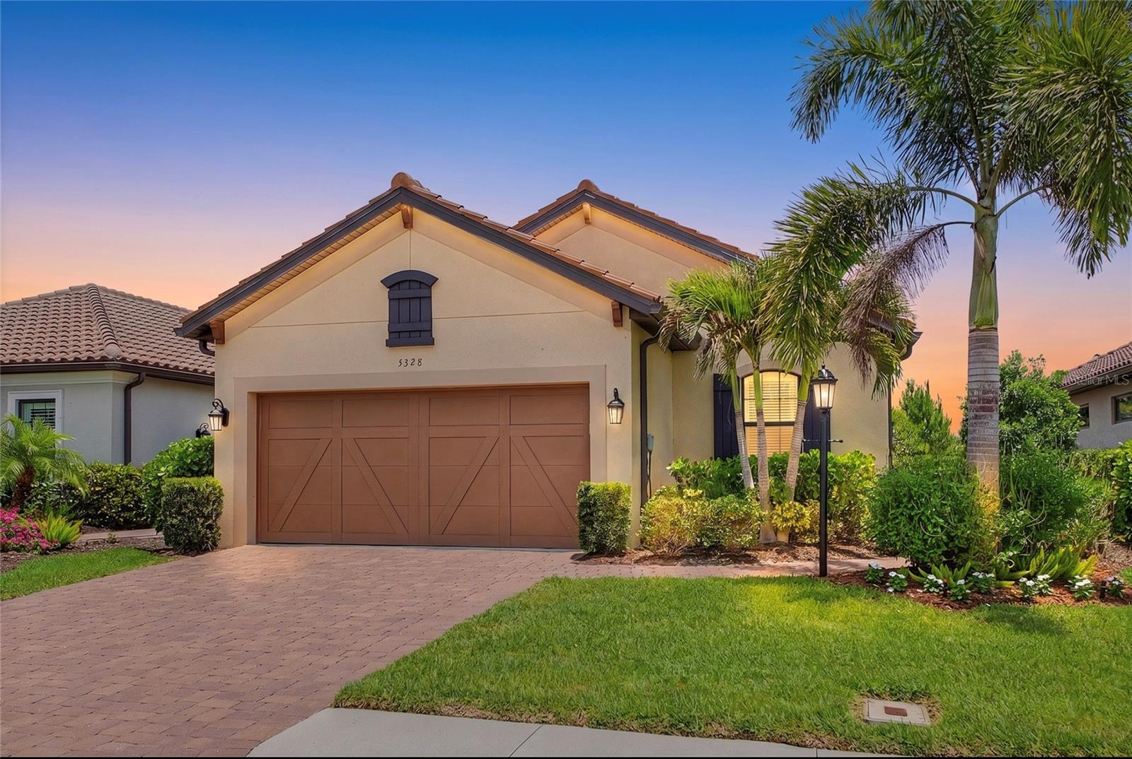 This stunning newly painted exterior Arezzo model is beautifully landscaped and located in Esplanade on Palmer Ranch - Sarasota’s premier gated resort-style community. This property, located on a quiet cull-de-sac street,  is being offered TURNKEY, FULLY FURNISHED featuring over $75,000 in premium upgrades. The home features a light and airy open concept design with 3 bedrooms, 2 bathrooms plus a den. Bordering a nature reserve, making for exceptional privacy and peaceful views. Key enhancements include 10’ ceilings, 8’ solid wood interior doors and a garage with 4’ extension and acrylic flooring. The natural gas kitchen features an abundance of cabinetry, work space, quartz counter tops and pantry plus flows seamlessly into the living and dining area. The primary suite serves as a welcome retreat featuring a bathroom with dual vanities and spacious walk-in closet. The second bedroom opens to the hall bath creating an on-suite for guests. Premium upgrades include: Luxury waterproof vinyl flooring in bedrooms and den installed 2025, plantations shutters and custom window treatments, whole house GENERAC generator and CULLIGAN water filtration system, extended screened lanai with a natural gas grill and pizza oven, new washer and gas dryer 2025, ceiling fans throughout, tray ceilings, upgraded exterior elevation and new exterior paint in 2025 and tile roof just cleaned! Front window has impact glass all other windows and doors have metal storm shutters located in the garage.  Esplanade on Palmer Ranch and Legacy Estates offer an active carefree living with world class amenities including an on-site Bahama Bar restaurant and bar with entertainment, resort-style pool, resistance pool, splash park, hot tub and covered lanai with fireplace. Plus a wellness room for massages, state of the art fitness center with daily classes and stretching room, 8 pickleball and 2 tennis courts, plus 3 dog parks. Residents also enjoy 2 direct gates access to the legacy Trail. Added bonus is lawn care including mowing, Irrigation, trimming and mulching! Convenient location within easy reach of Siesta Key Beach, downtown Sarasota, downtown Venice and local beaches. Convenience continues with quick access to major roads, restaurants and shopping including UTC.  Isn’t it time to start living the Florida Lifestyle?