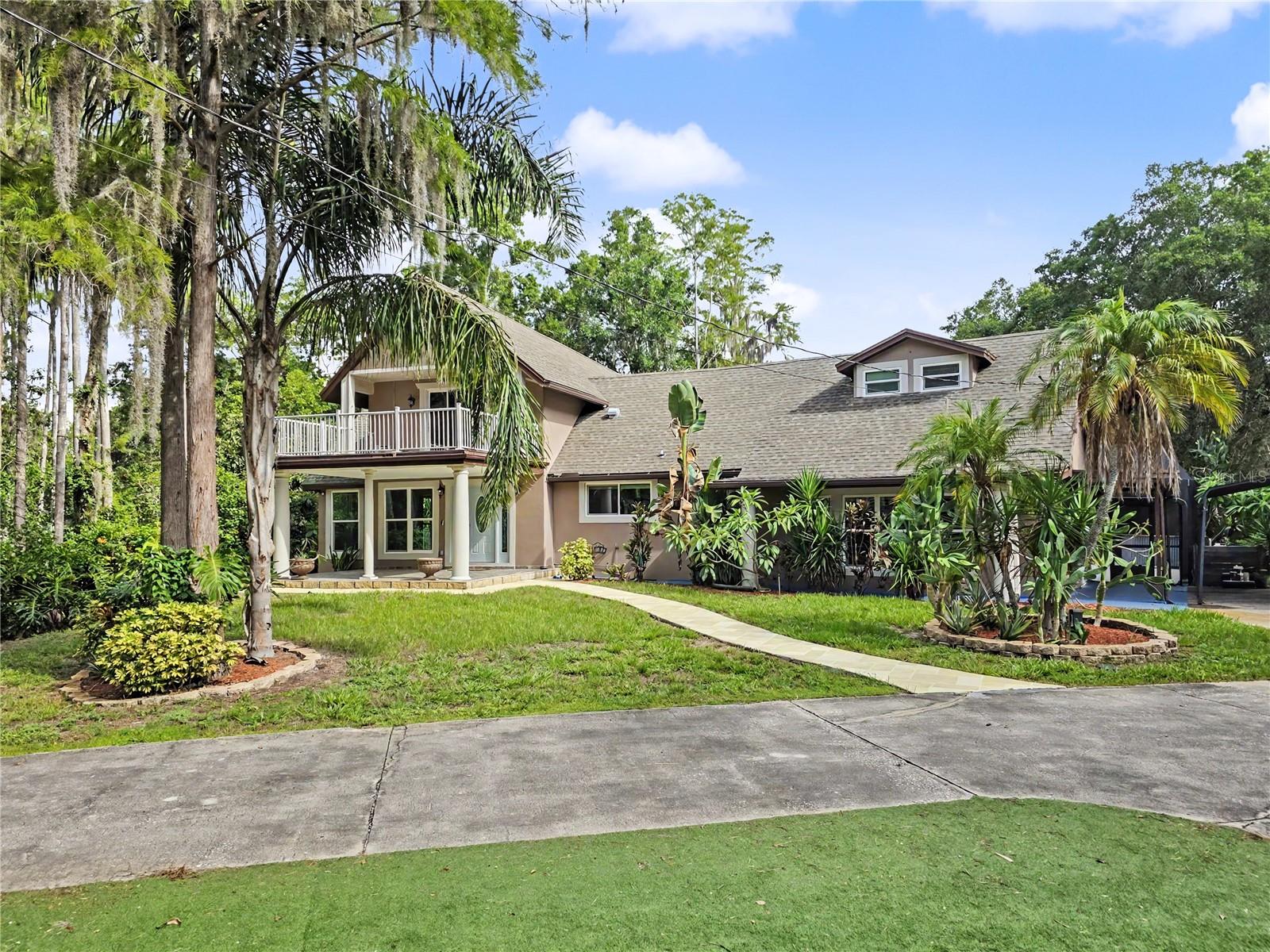 Auction Property. ***Luxury Live Auction! *** Transparent Non-Distressed Auction! *** Saturday, August 8, 2026, at 10:00am. Preview from 9:00 am on Sale Day. Because this is an auction sale, the home may sell for less or more than the list price. The home is being sold free and clear of all debts and is guaranteed by title insurance, like any other traditionally listed home.
Set back at the very end of a peaceful cul-de-sac, this private gated property offers the kind of space, privacy, and flexibility that is becoming harder to find. Located in the desirable Oak Ridge community, this estate sits on more than 2 acres with no HOA, giving you room to live, park, store, entertain, and enjoy the property without the usual neighborhood restrictions. The setting feels tucked away, yet the location keeps you close to everything. Shopping, Dining, Entertainment, and a short drive to the Tampa International Airport, Tarpon Springs, the Sponge Docks, major roadways, Pinellas County, Hillsborough County, beaches, and everyday conveniences are all within easy reach. A keypad-entry drive leads into the property, where mature landscaping, open outdoor space, a screened saltwater pool, a pond, a fire pit area, a storage shed, and generous parking create a true private retreat. There is room for boats, RVs, work vehicles, guests, and more. Inside, the home offers 4 bedrooms, 2.5 bathrooms, and 2,743 square feet of living area with a bright, open feel. High ceilings, a skylight, formal living and dining areas, and a spacious great room give the home a comfortable layout for both daily living and entertaining. The first-floor primary suite opens to a private deck overlooking the backyard, creating a quiet escape within the home. Upstairs, an oversized bedroom with its own balcony offers excellent flexibility and could serve as a second primary suite, guest suite, media room, or private retreat. The fourth bedroom is also highly versatile and would work well as an office, gym, hobby room, or additional guest space.
The home has seen several important updates, including a 2016 remodel, a 2022 refresh, new interior paint, and recently replaced AC units. With its acreage, privacy, pool, flexible floor plan, and no-HOA setting, this property offers a rare opportunity to own a private estate-style home in one of the area’s most convenient and desirable locations.