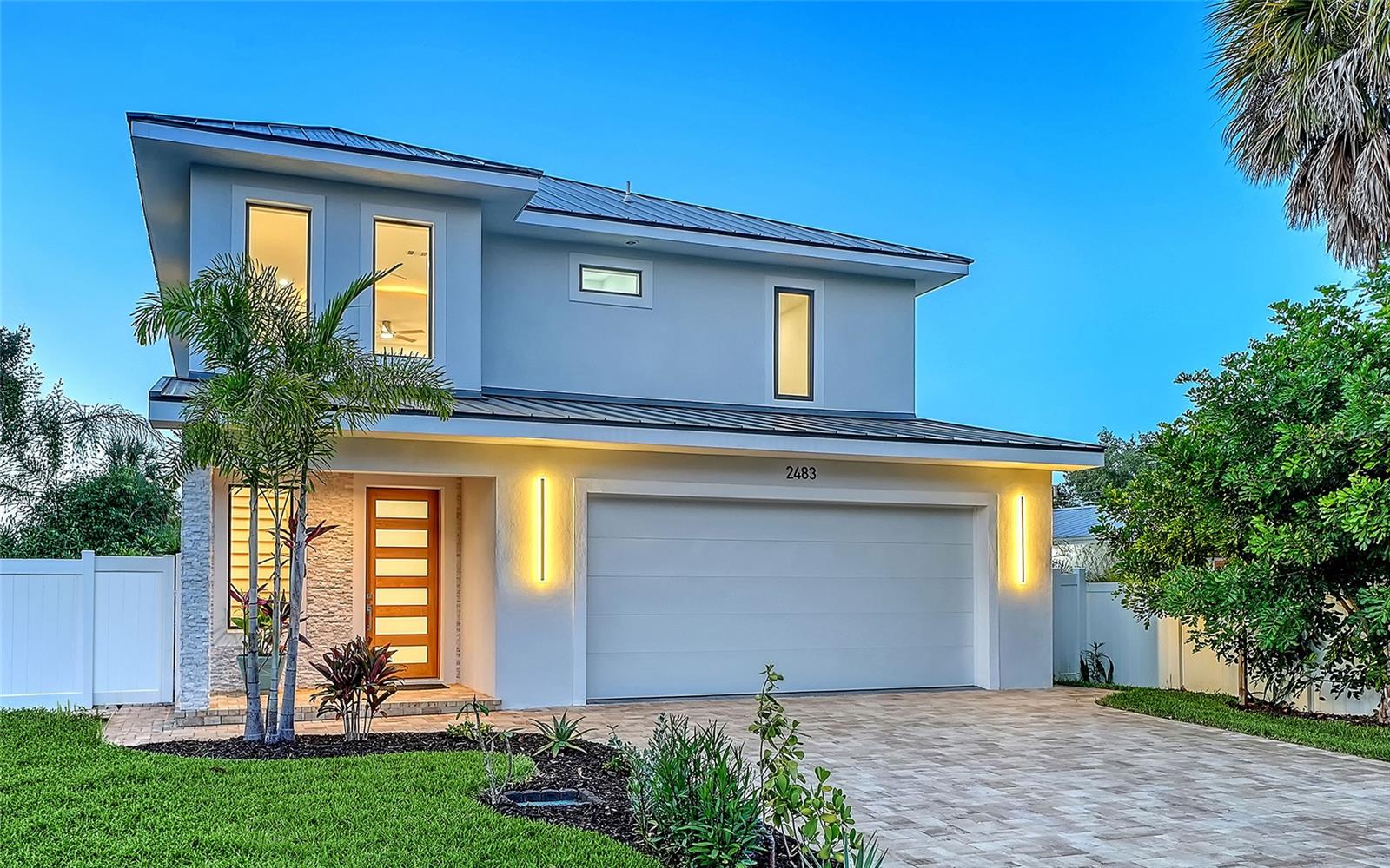 Virtually Staged. Brand new and ready to move in, this Alta Vista home puts the best of Sarasota’s dining, culture, parks and professional corridors within minutes in every direction. This home was built by the owner, a certified general contractor and pool builder, who was not merely a supervisor, but a craftsman who worked alongside his crew from foundation to finish.

The 4-bedroom, 3.5-bath residence with loft offers 2,976 sq. ft. of air-conditioned living across two floors of solid concrete block construction beneath a pitched standing seam metal roof, with R-38 spray foam insulation built into every wall and ceiling. Inside, a two-story foyer with chandelier leads to 10-foot ceilings on both levels. The open-concept first floor features a coffered ceiling with cove lighting, 30×30 high-gloss porcelain tile set on the diagonal, decorative in-wall niches with accent lighting, 8-foot solid-core doors and a climate-controlled wine room. Engineered hardwood floors carry the refined quality upstairs.

Natural stained shiplap ceilings in the covered entry and lanai extend the interior’s character outward. Beyond the lanai, a 28×12 pool with a 6-foot sun shelf and 6’6? deep end sits within a fully fenced and gated backyard that reaches well beyond the water’s edge. Brick paver driveways and walkways in a geometric ashlar pattern with accent borders reinforce the home’s handcrafted appeal. A thorough systems list rounds it out: dual A/C systems, an oversize 2-car garage with EV charger, central vacuum, impact windows and sliders, and a 375-gallon propane tank.

The location alone is hard to match: Southside Village and Sarasota Memorial Hospital one mile south; Payne Park and downtown one mile west; Sarasota Bay within two miles; Lido Beach and Siesta Key within six miles; and the Legacy Trail two blocks from your front door. This is a home, and a neighborhood, that makes daily life feel like it was made just for you.